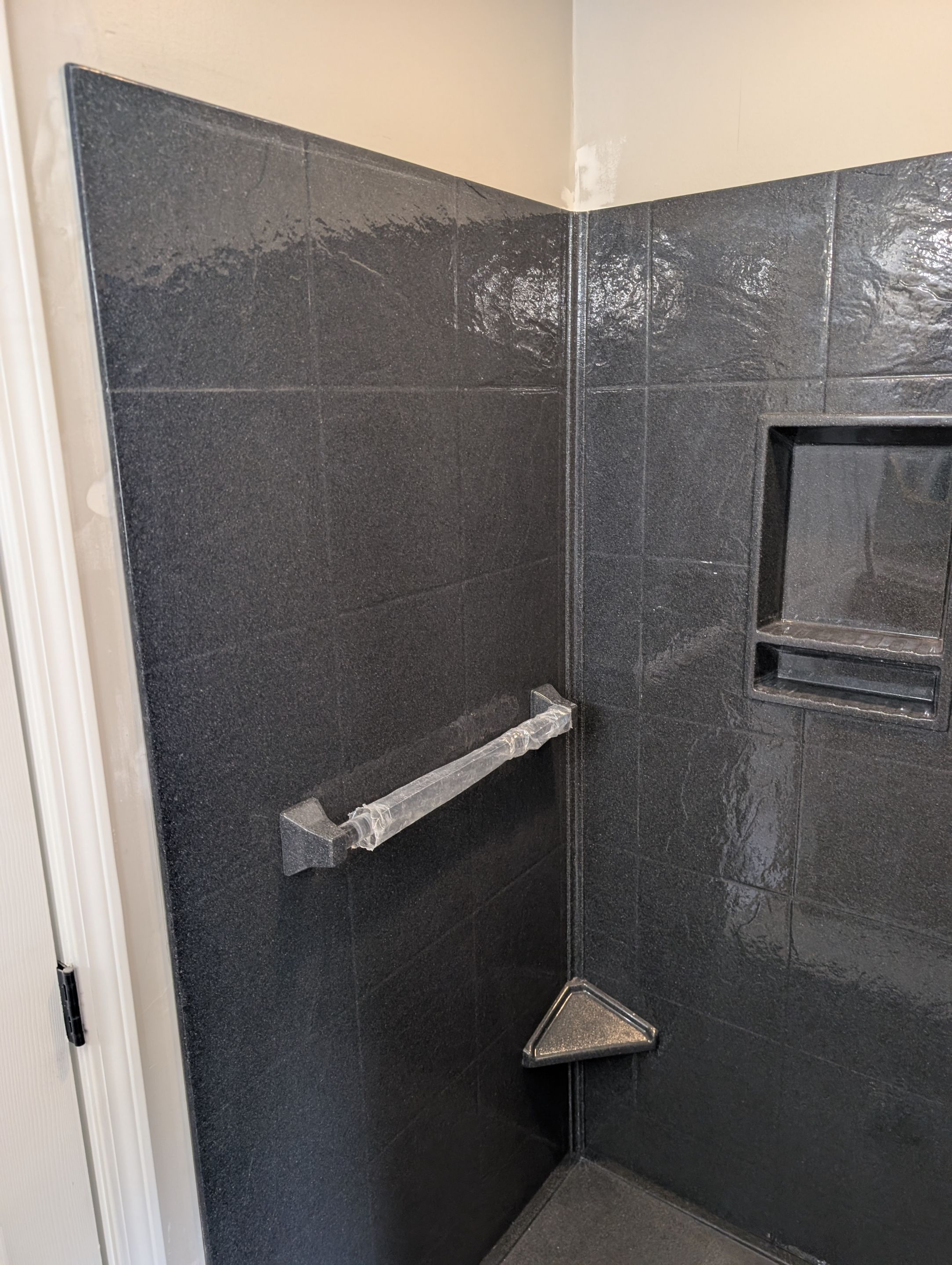 Master Bathroom Renovation Featuring Dark Textured Shower Panels in Branson West by Kitchen Works LLC