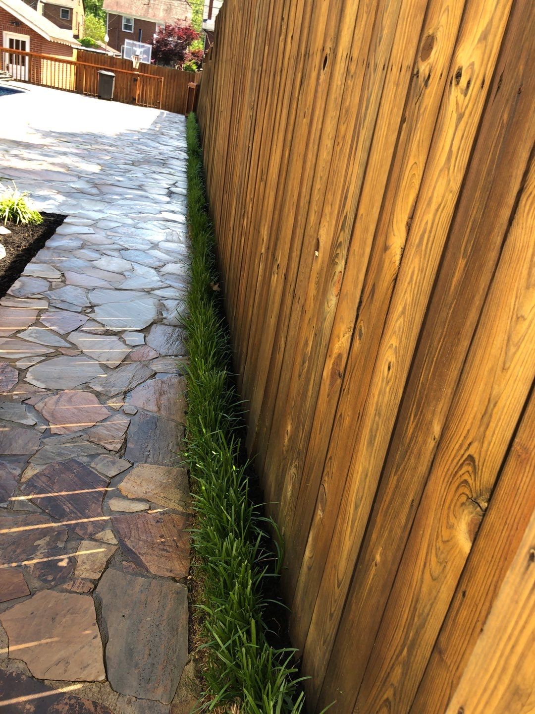 Liriope grasses, mulch and stone pavers by GrassBusters, Inc.