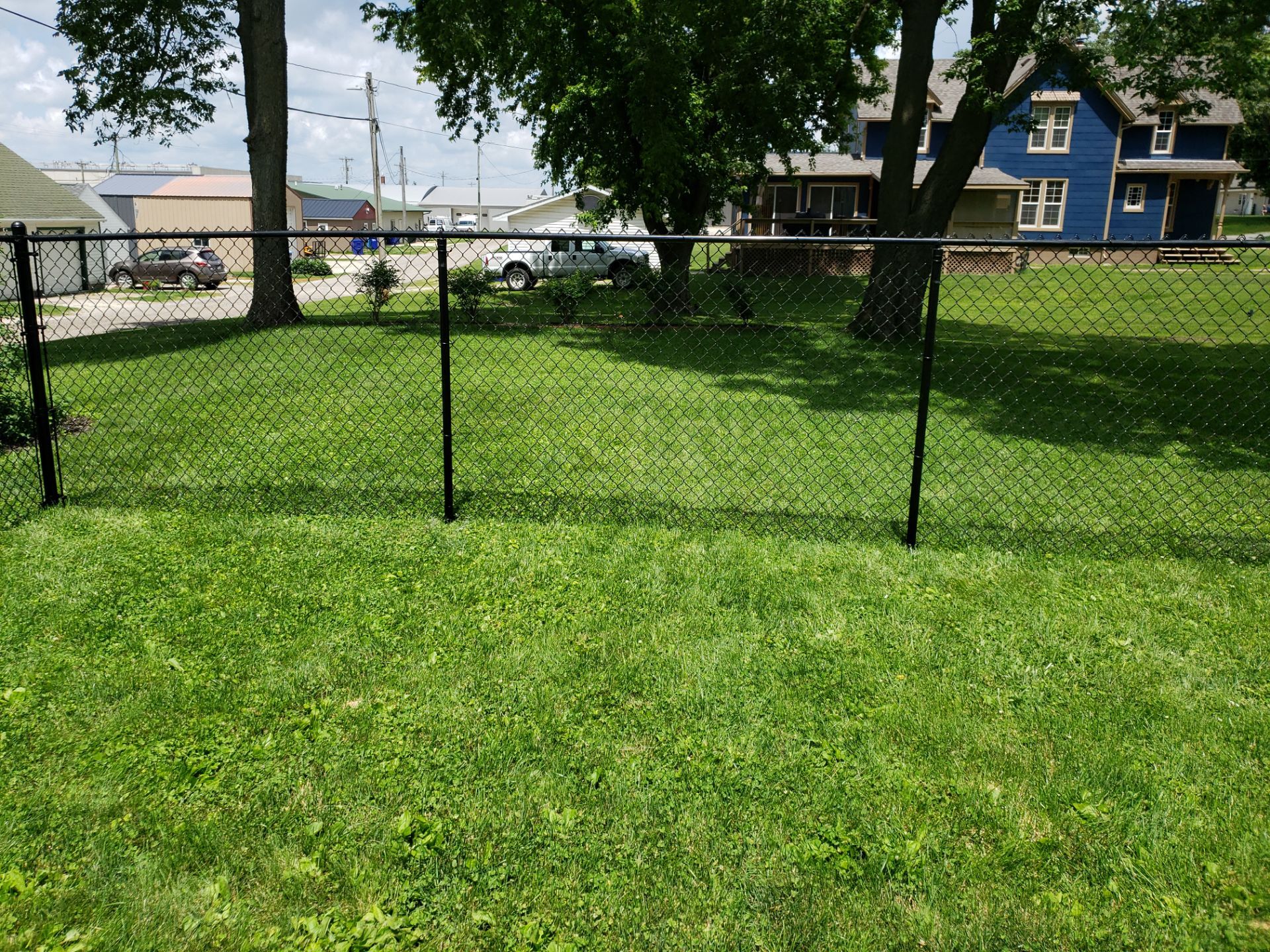 Black Vinyl Coated Chain Link Fence Installation in Independence by Perfect Picket Fence and Stain