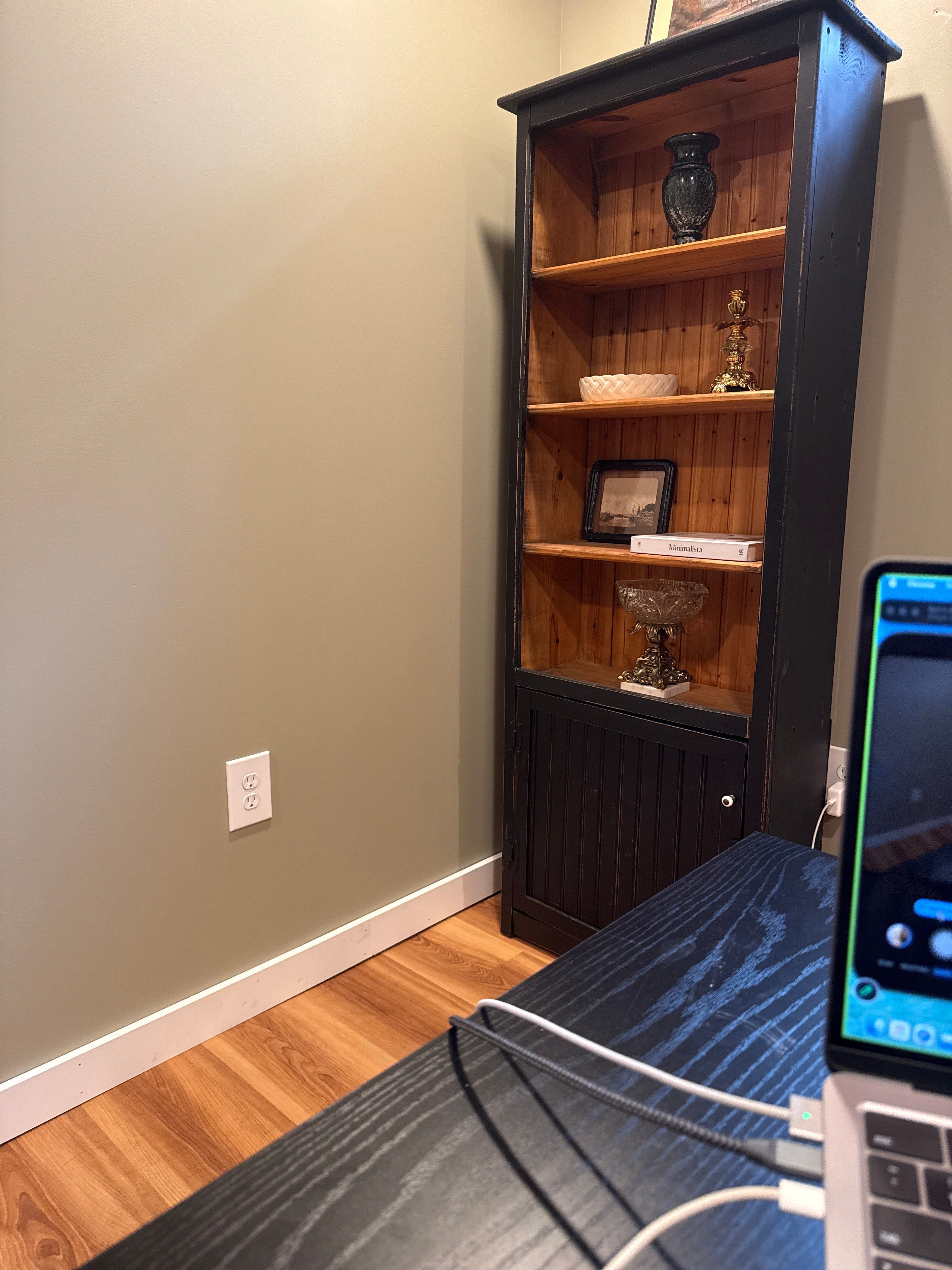 Home Office Setup with Sage Walls and Dark Wood Shelving by CompanyCam Sales Demo