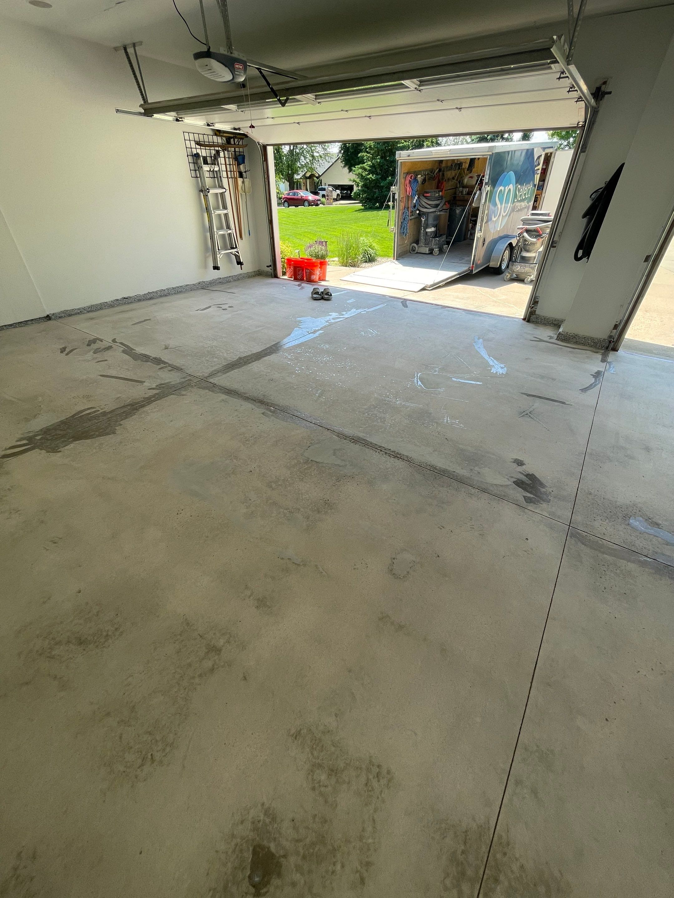 Feather Grey Garage Floor Coating Installation in Sioux Falls by Select Painting, Coatings & Garage Cabinets