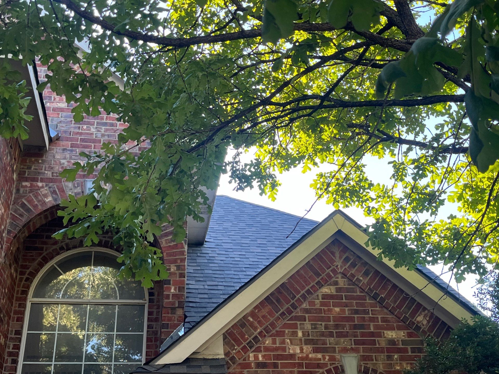 IKO Cornerstone-Dark Reddish Brown brick house  by Tejas Roofworks + Restoration