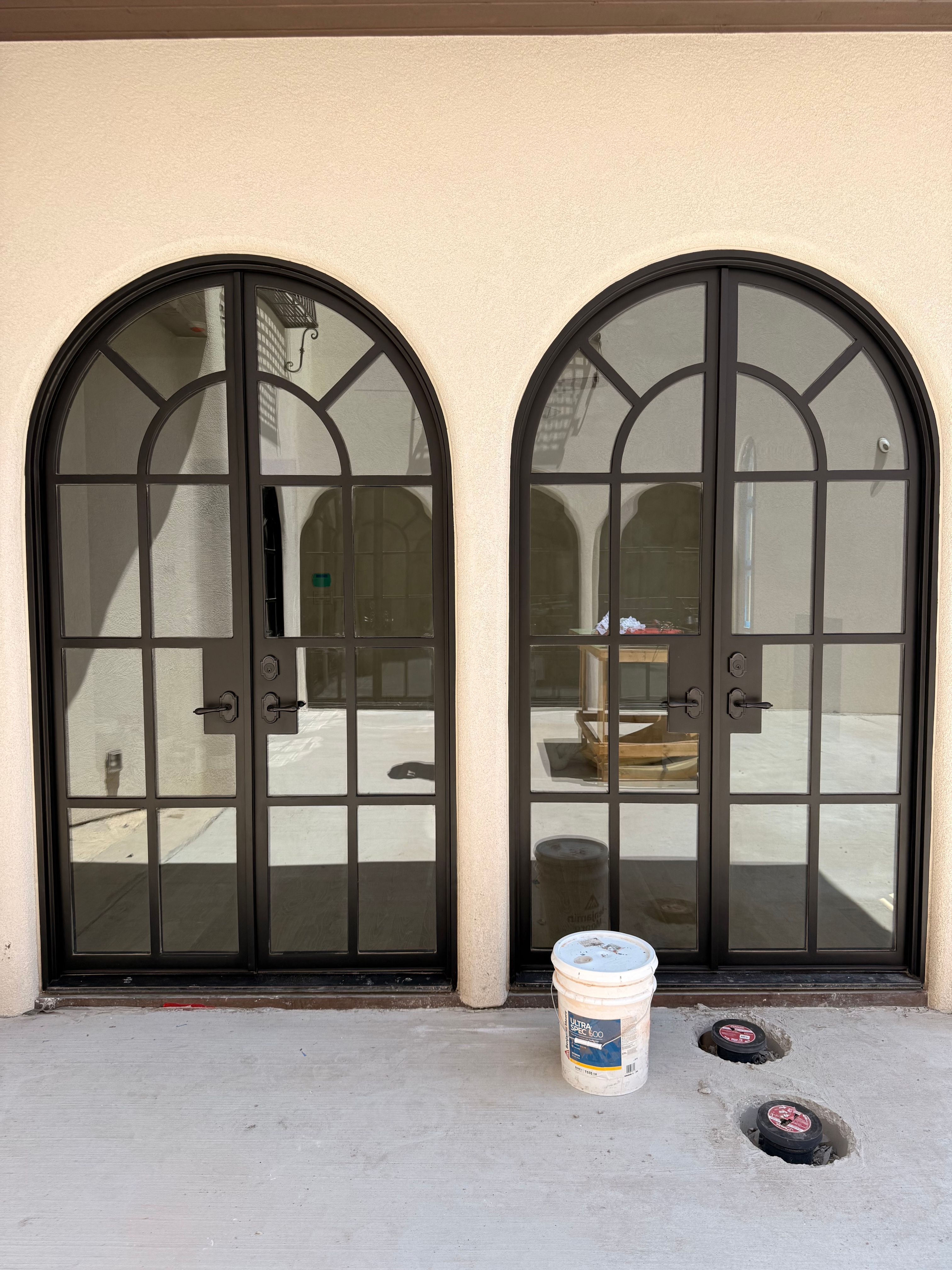 Arched Black Metal French Door Installation and Finishing in Fort Worth by Solara Custom Living
