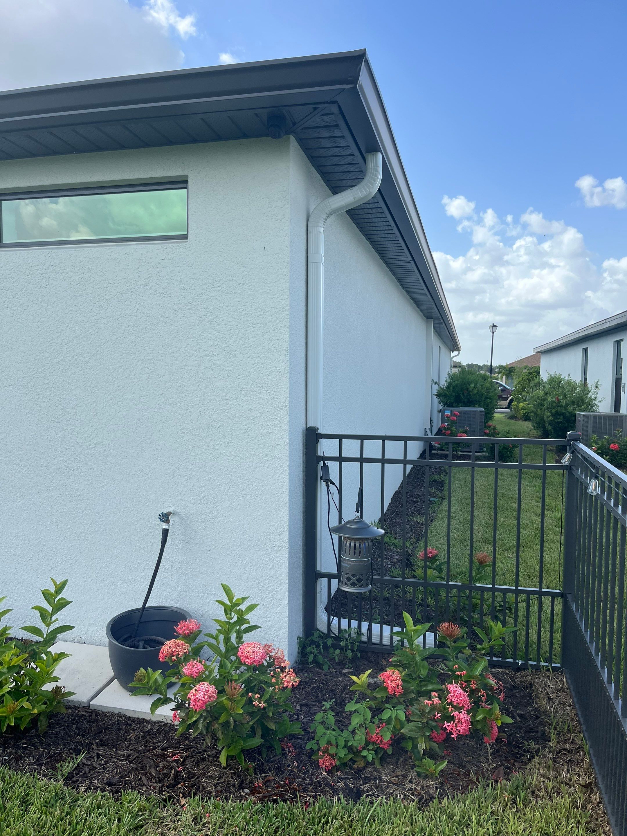 Dark Bronze Gutters and White Downspouts in Sarasota FL by Gutter Professors