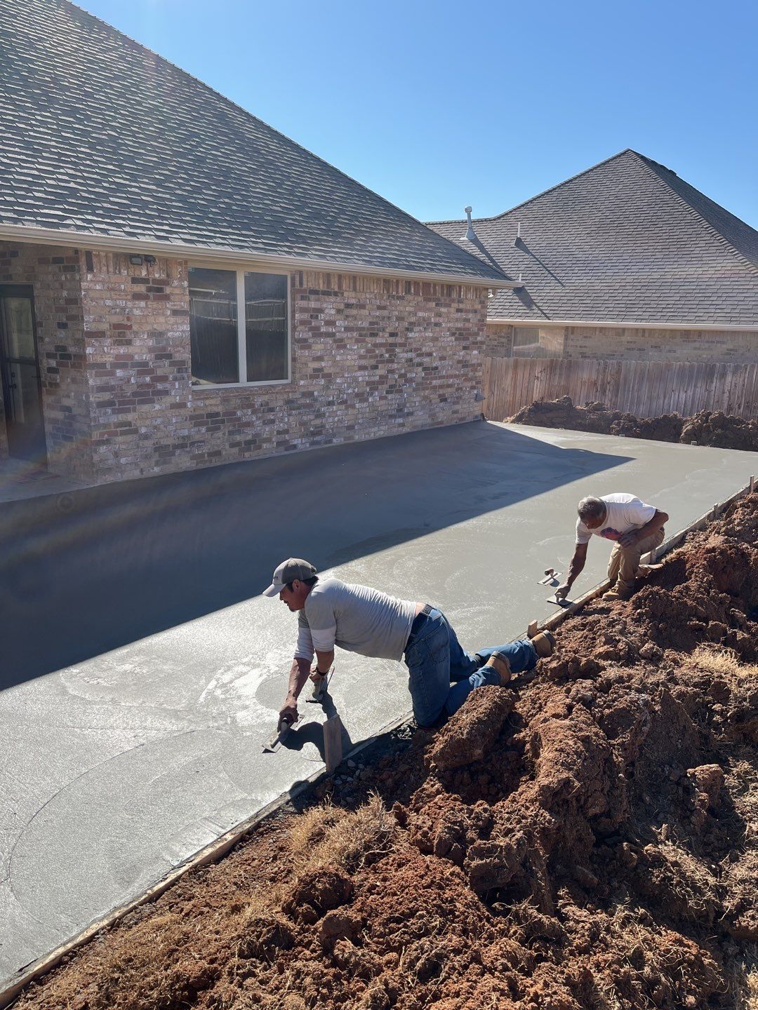 Concrete Slab , Retaining Wall , Fence, and landscape. by Clays Services Inc