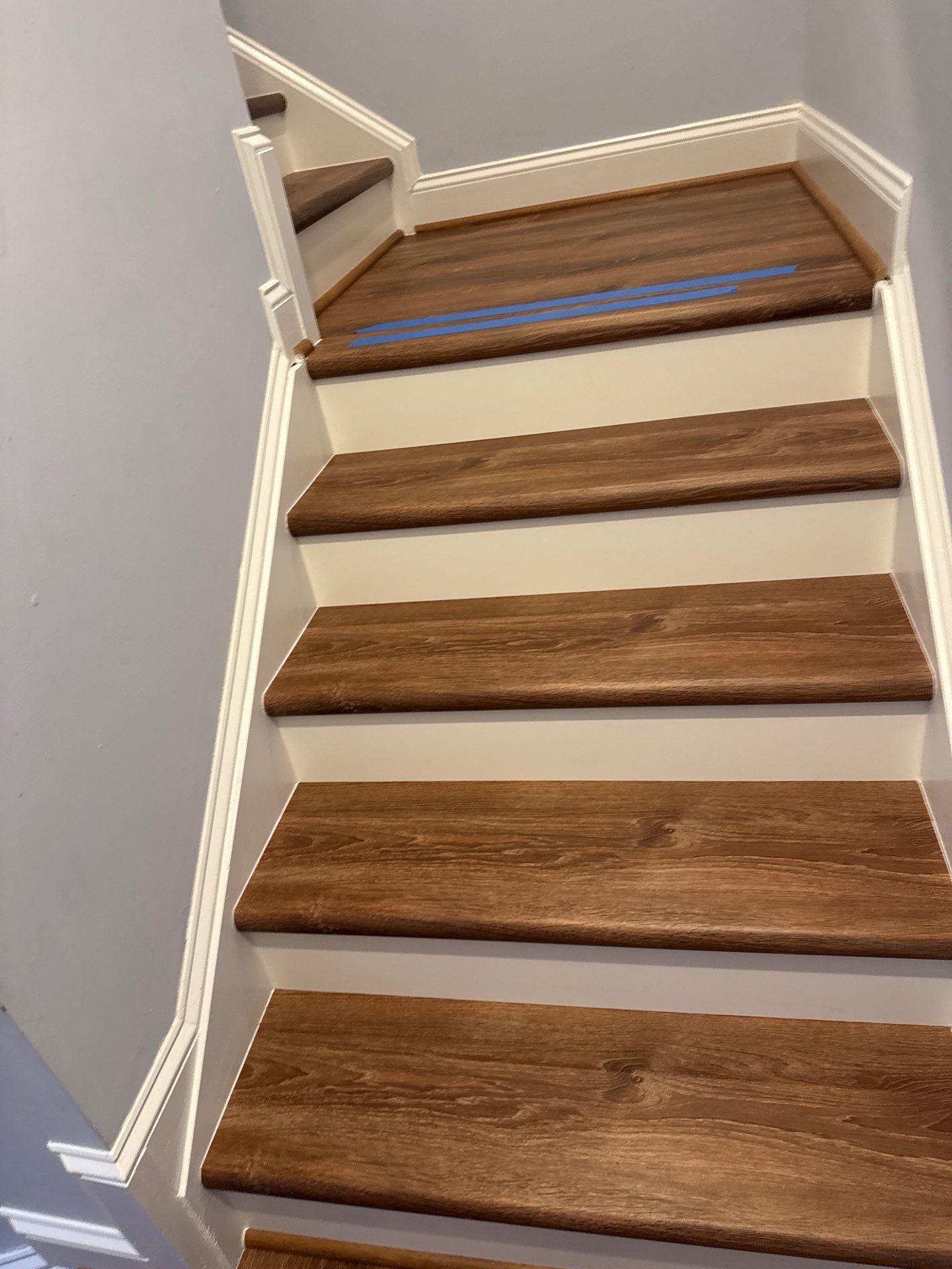 Stairway Installation using t vinyl stair tread and reversibleriser by La Bendicion Contruction Llc