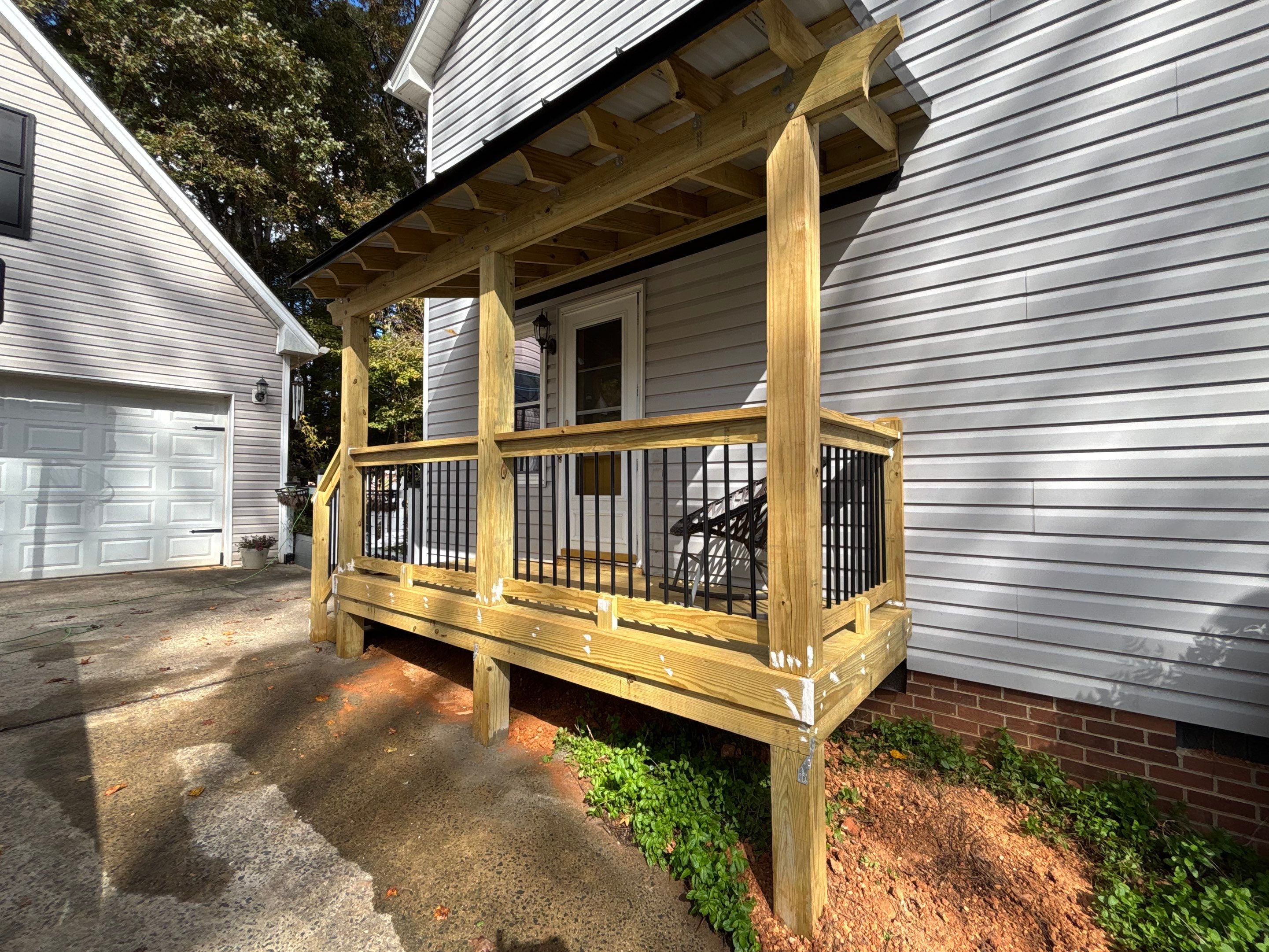 Custom Pressure-Treated Deck and Metal Roof Installation in Durham by The Remodeling Company