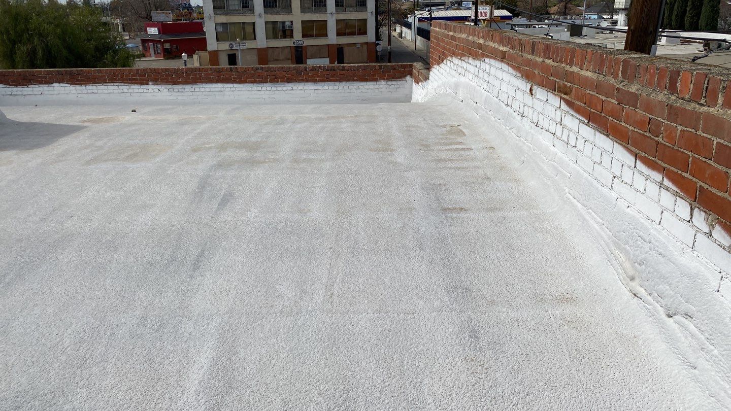 Polyurethane foam roof refurbish and recoating by Straight Edge Roofing Inc