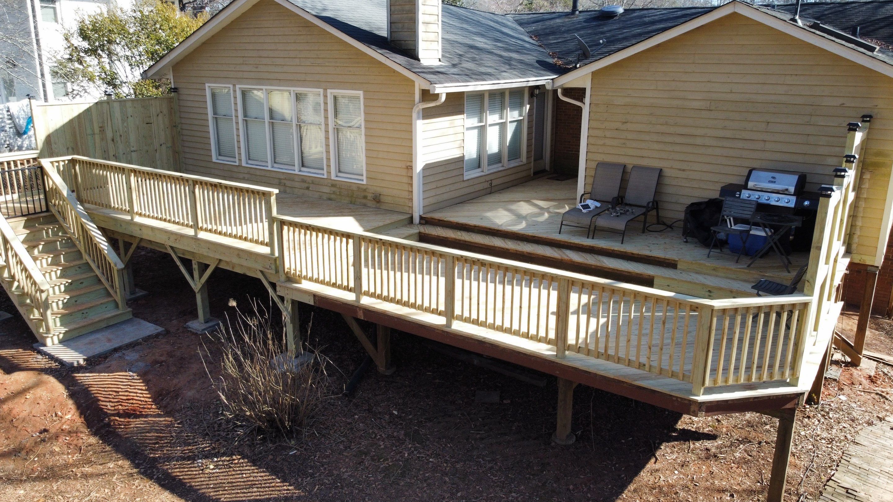 Elevated Pressure-Treated Wood Deck Extension in Marietta by Swift Home Renovations