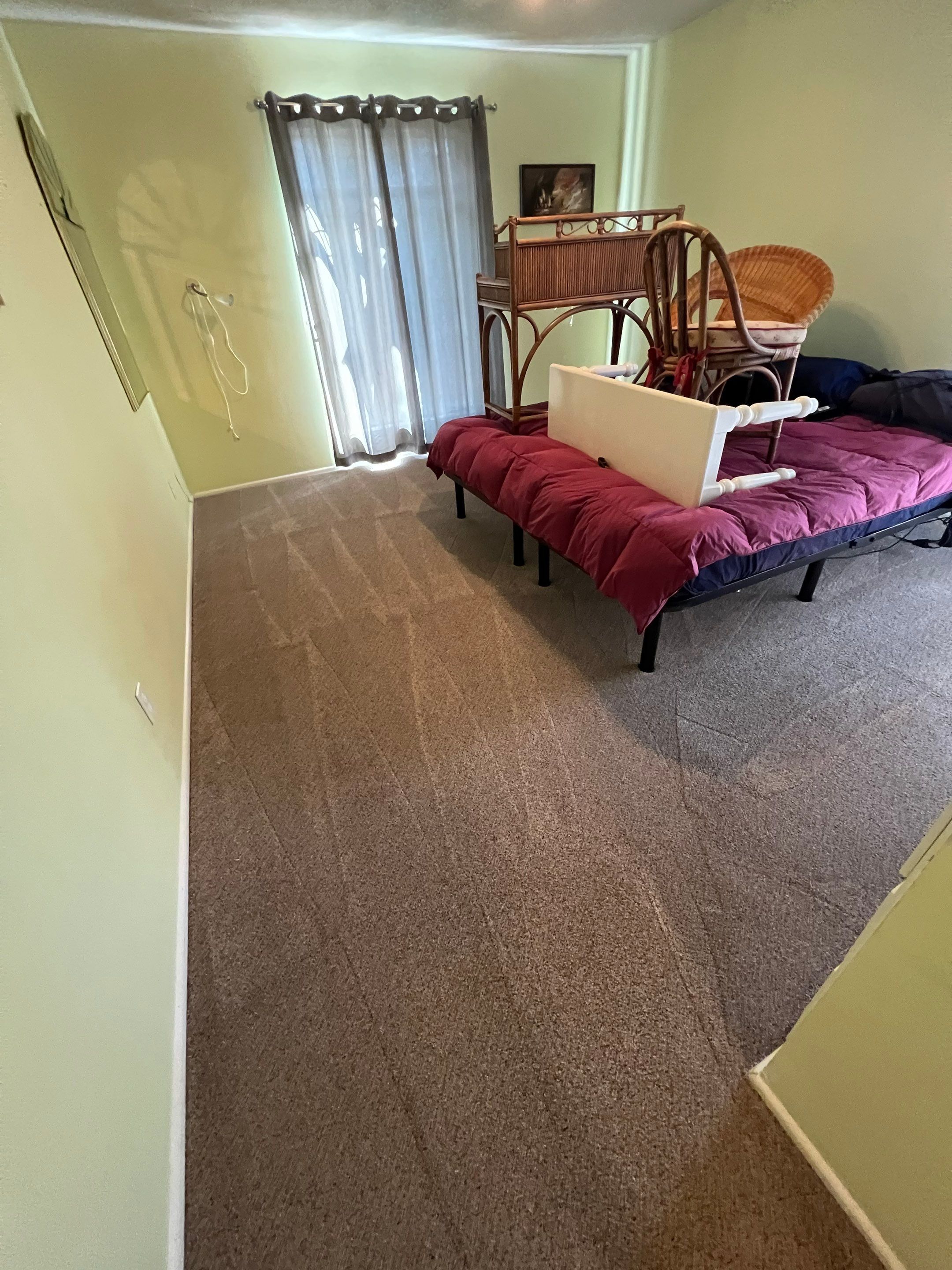 the service shown is carpet cleaning in a bedroom with furniture temporarily moved off the carpet for thorough cleaning