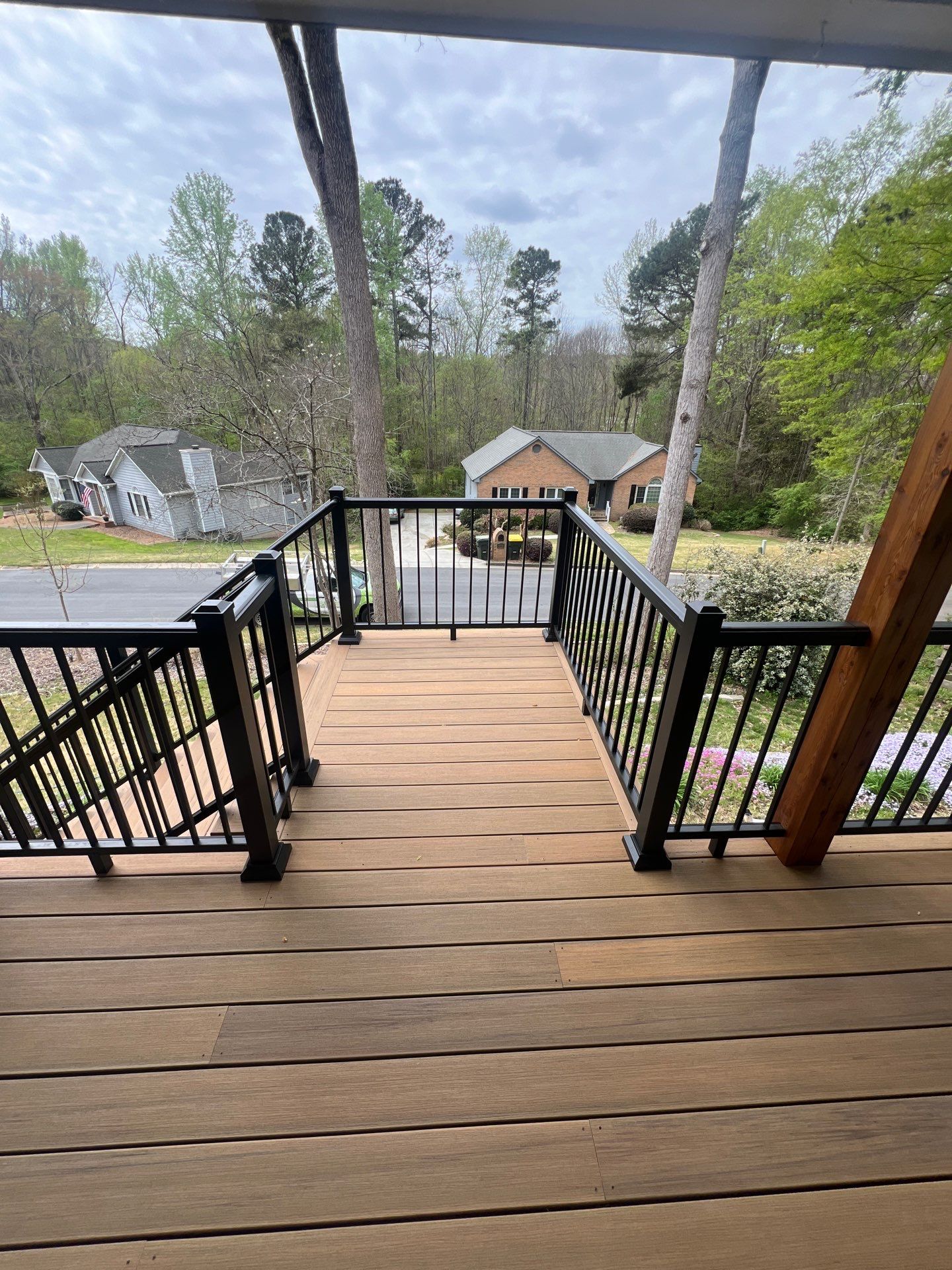 Composite Deck and Porch Renovation With Black Metal Railings by Swift Home Renovations 