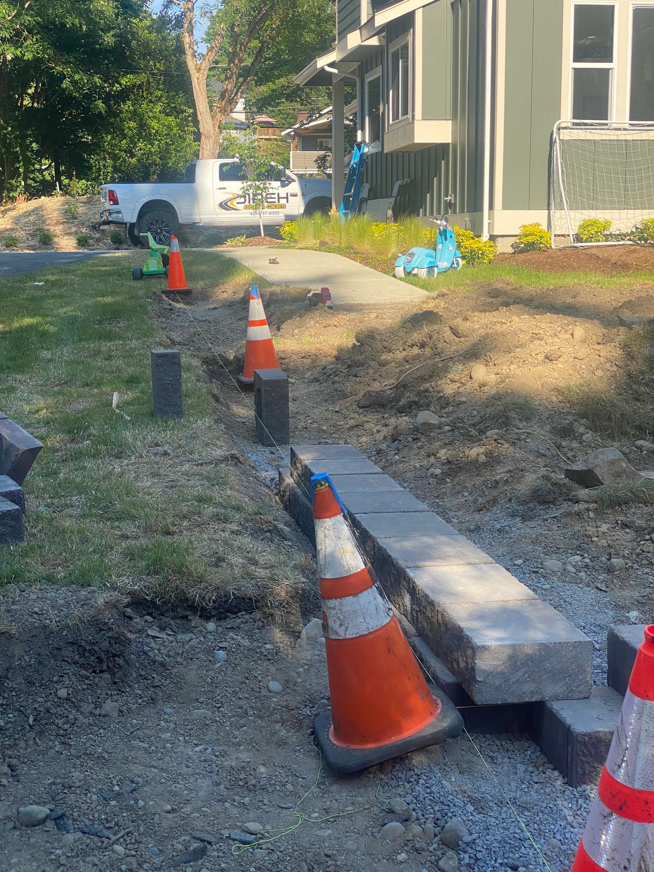 Patio Installation using Concrete, Retaining walls, and Turf install by Jireh Asphalt & Concrete Inc 