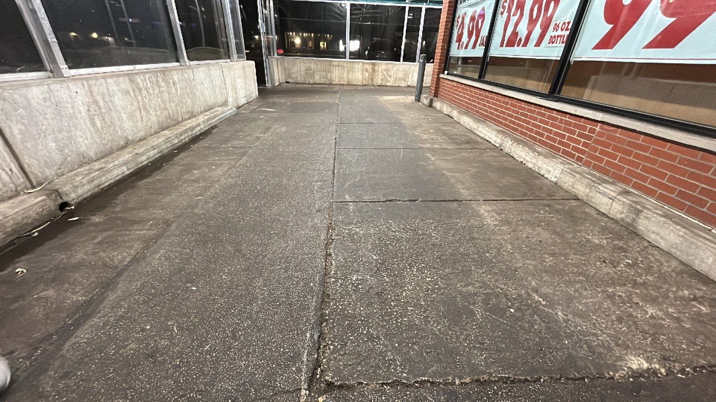Concrete sidewalk cleaning and degreasing by Northern Power Washing LLC.
