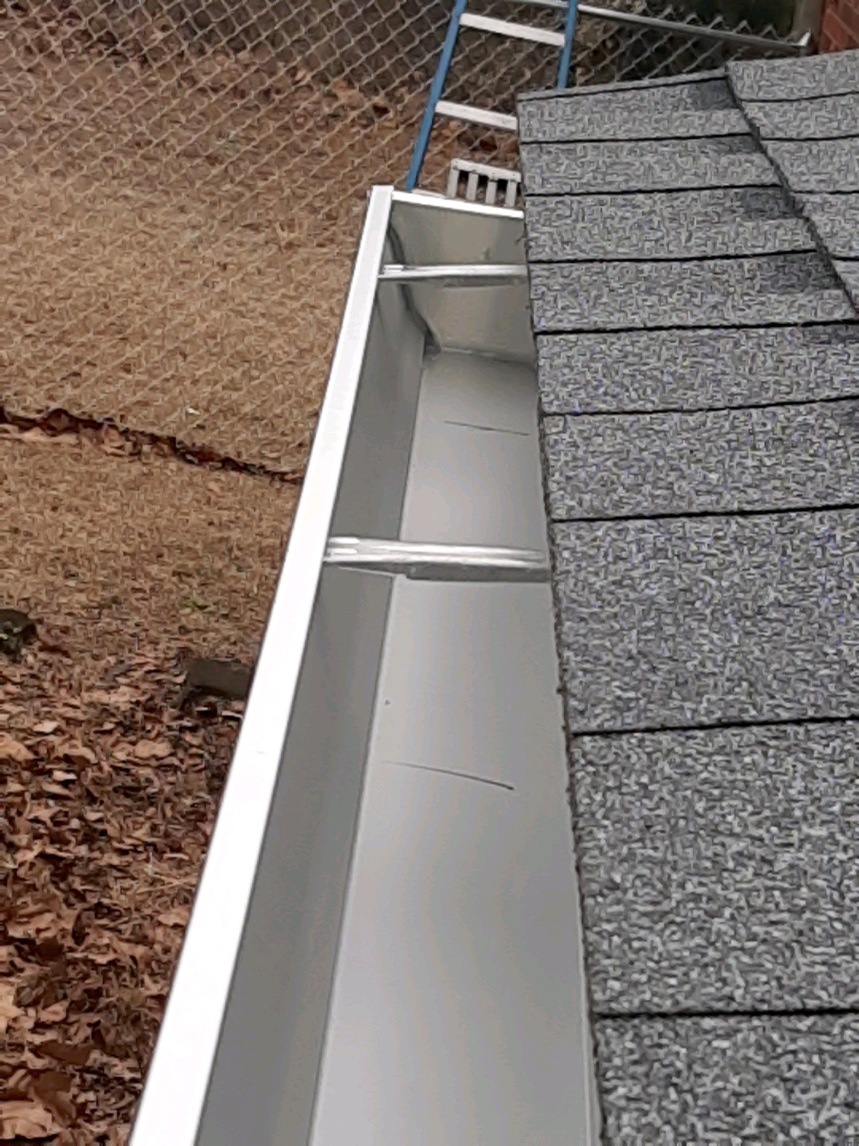 Gutter Installation using White Seamless Gutters by Gutter Professors