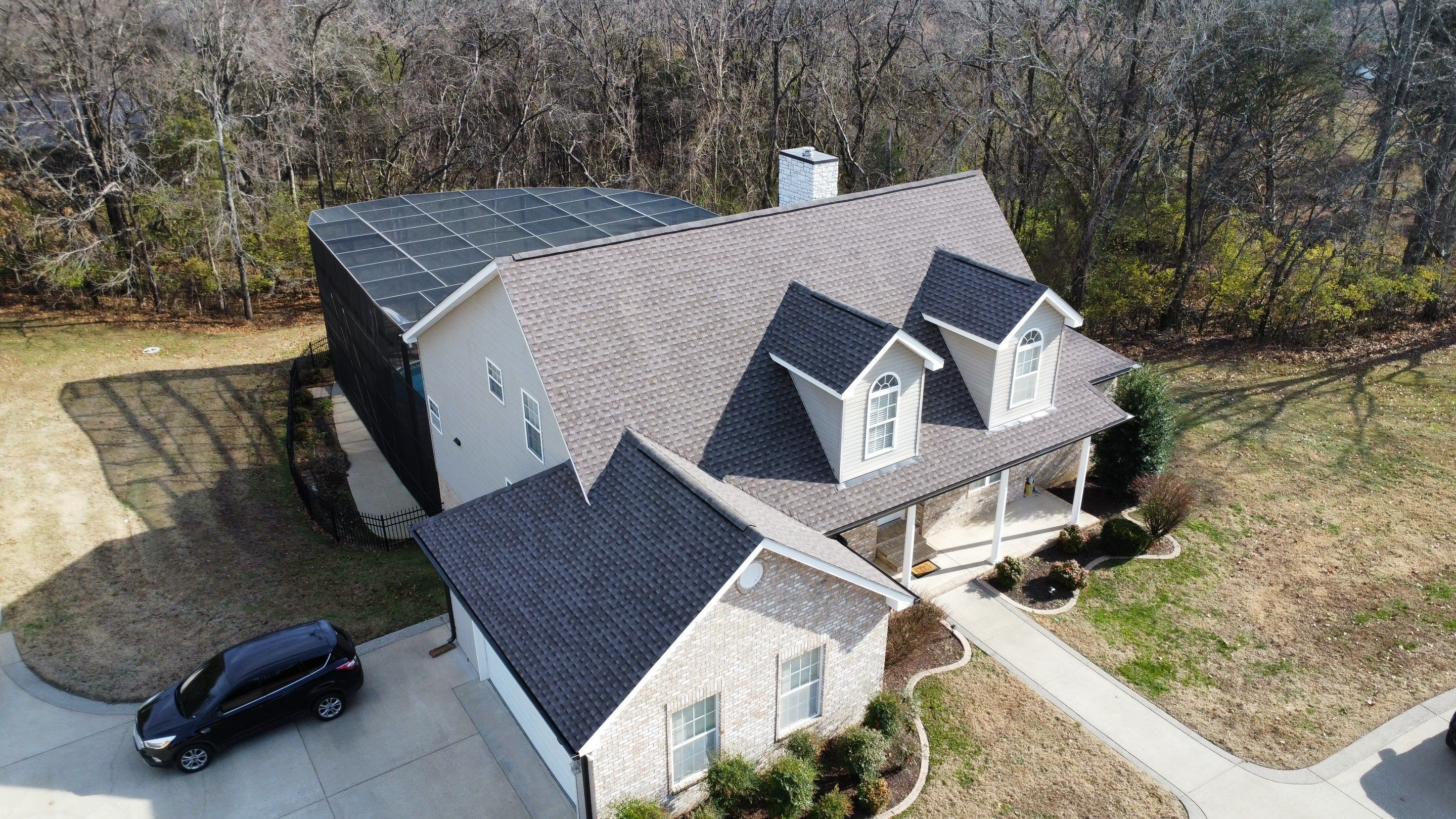 Roof and Gutter System Replacement with Stone Chimney Rebuild by Undersun Roofing 