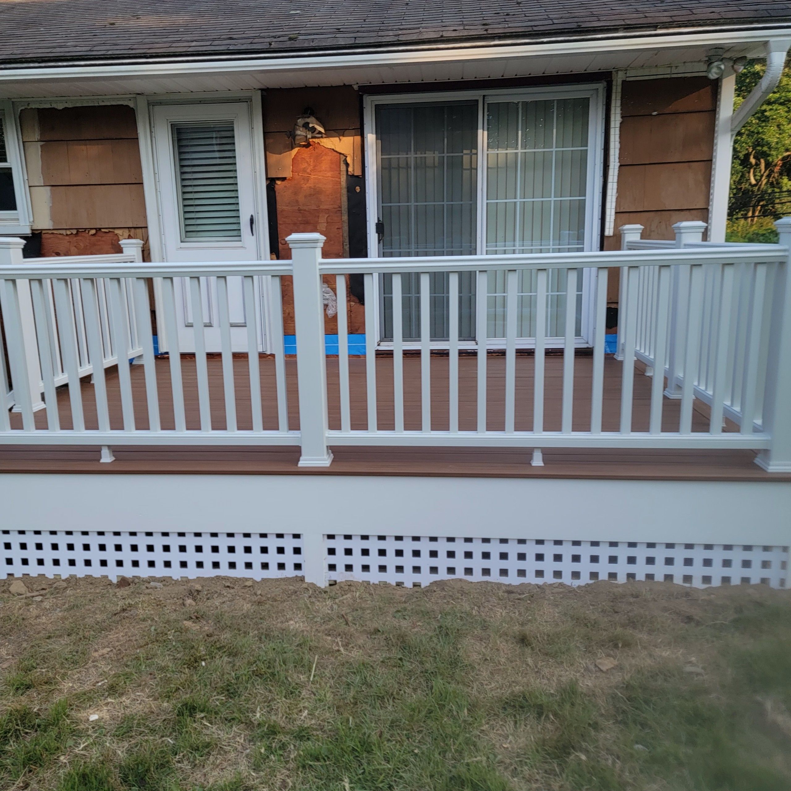 Deck Replacement using Trex Tropical Tiki Torch and White Transcend railings with lattice bottom by DiGiorgi Roofing and Siding Inc