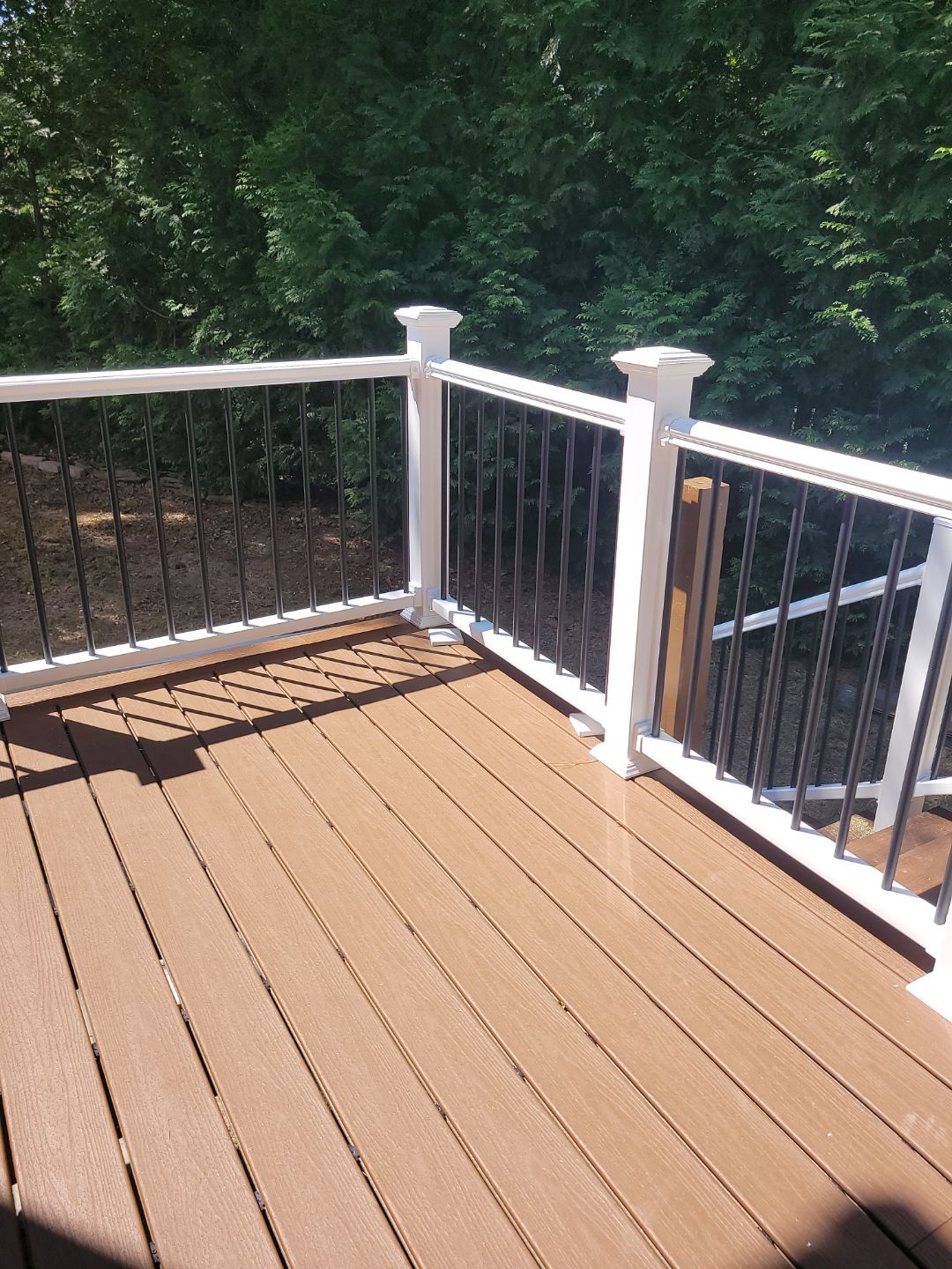 Fuquay-Varina Outdoor Upgrade – Composite Deck & Paved Landing by Elite Remodeling and Design LLC