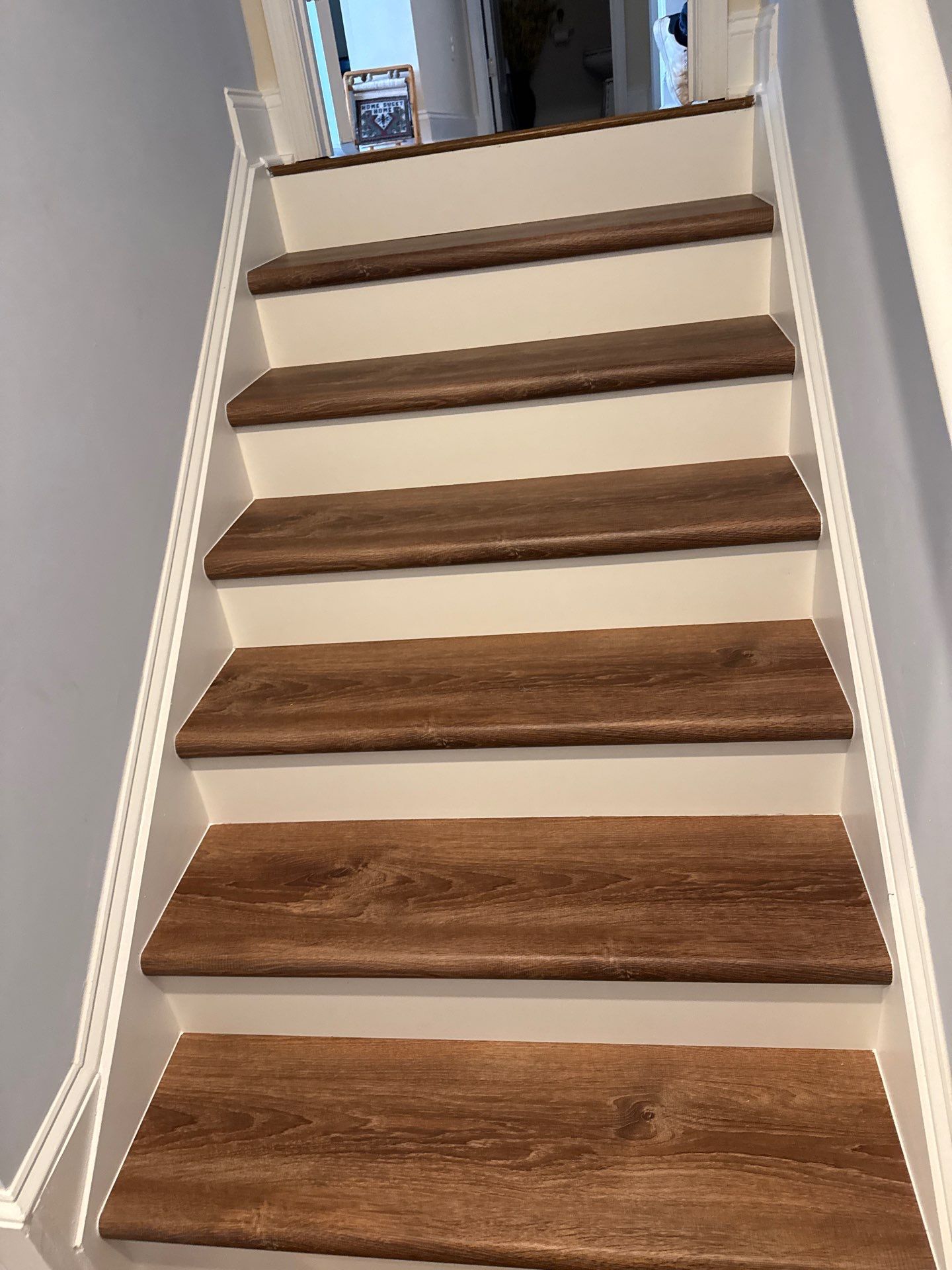 Stairway Installation using t vinyl stair tread and reversibleriser by La Bendicion Contruction Llc