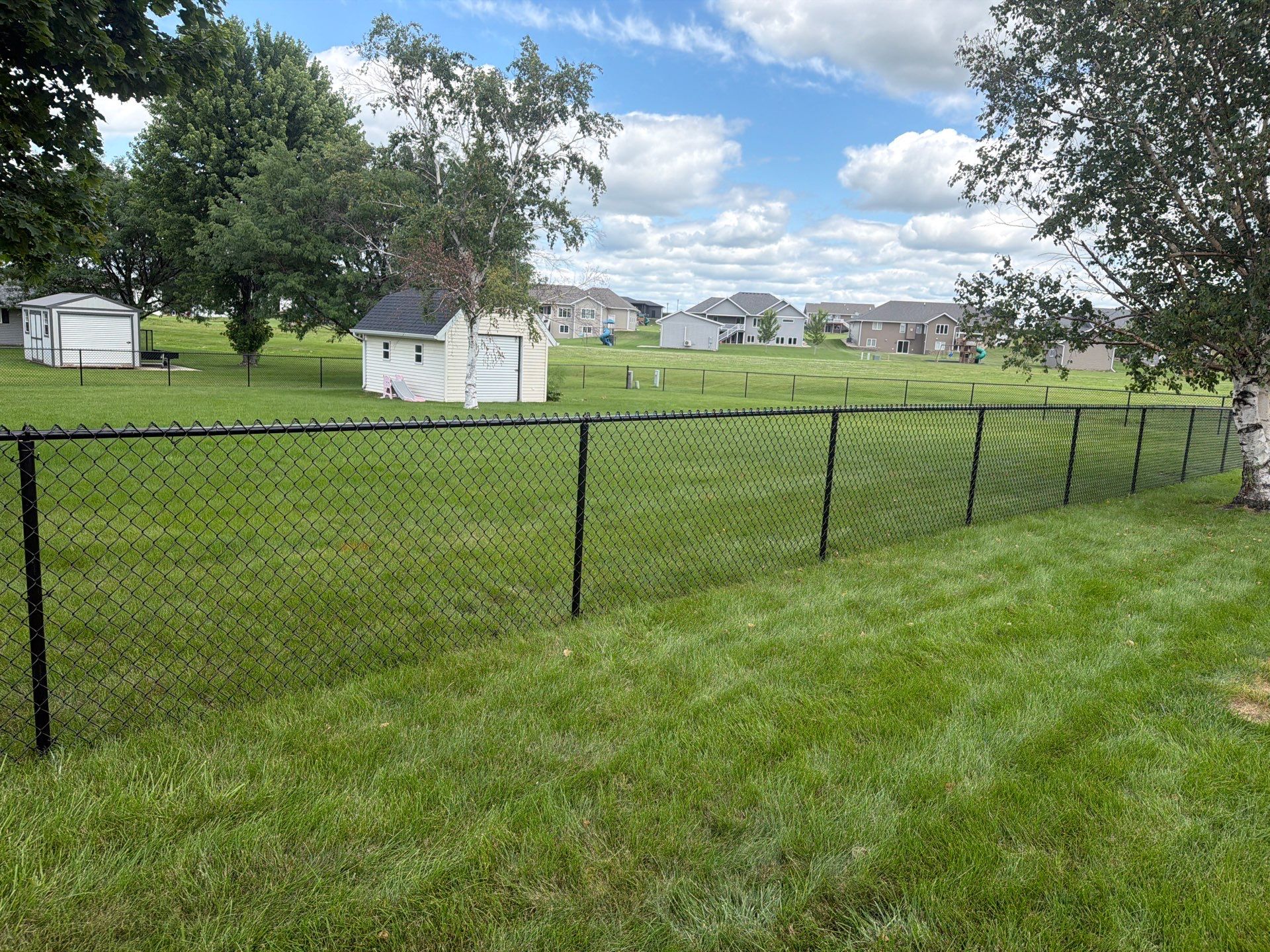 Black Vinyl-Coated Chain Link Fence Installation in Fairbank by Perfect Picket Fence and Stain
