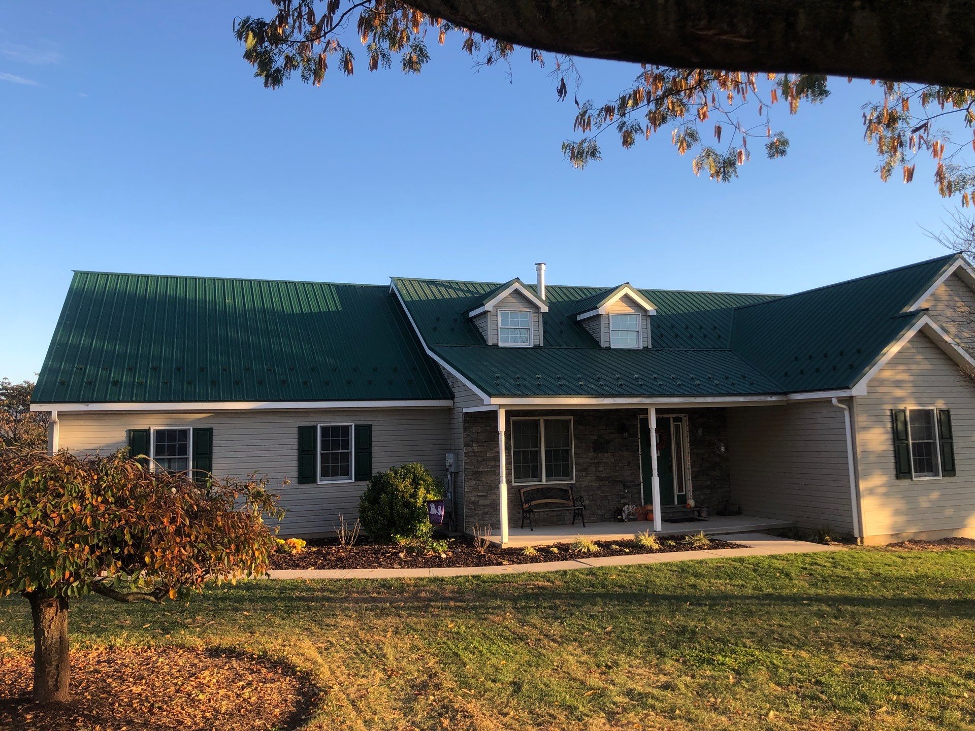Green Metal Roof and Custom Covered Deck in Duncannon by Esh Builders