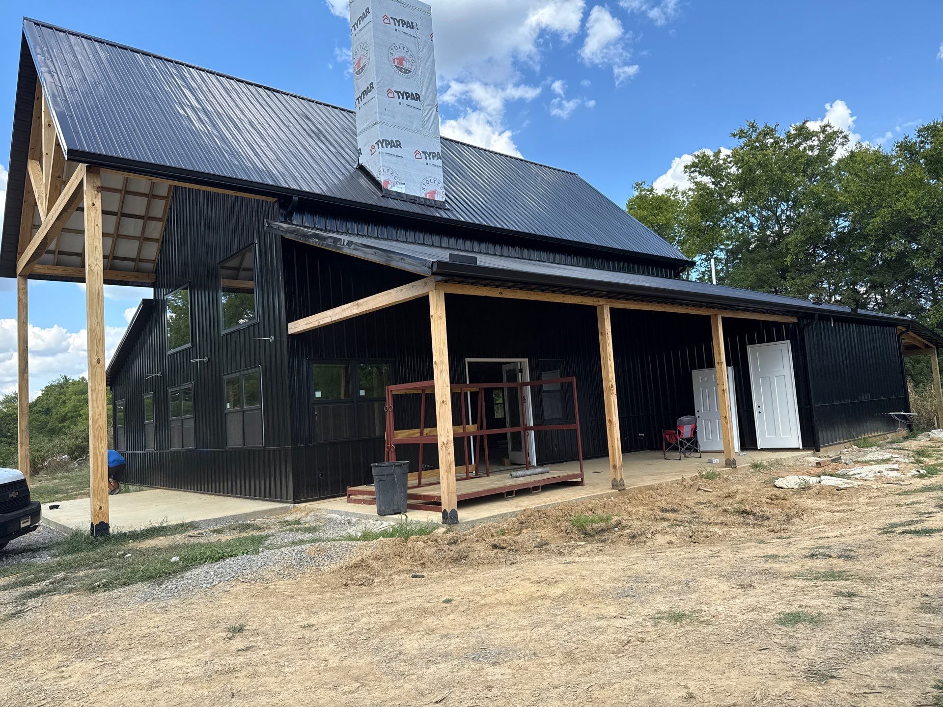 Black gutters on black building  by First Choice Gutters LLC
