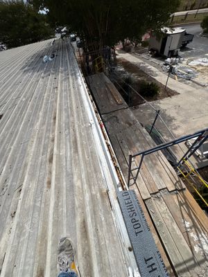 Worker on a metal roof during an installation project.