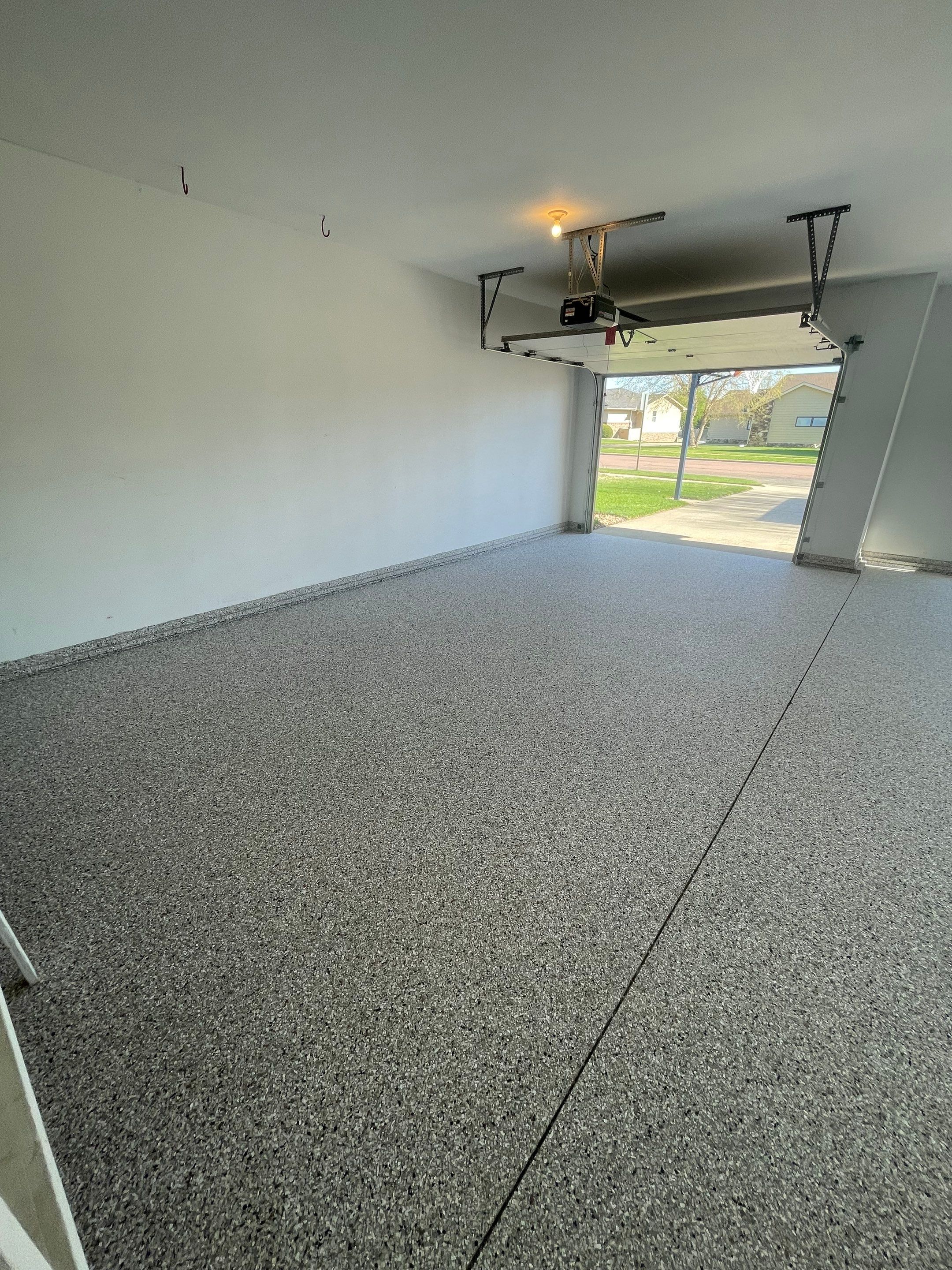 Yankton Garage Floor Restoration with Gray Speckled Epoxy Coating by Select Painting, Coatings & Garage Cabinets