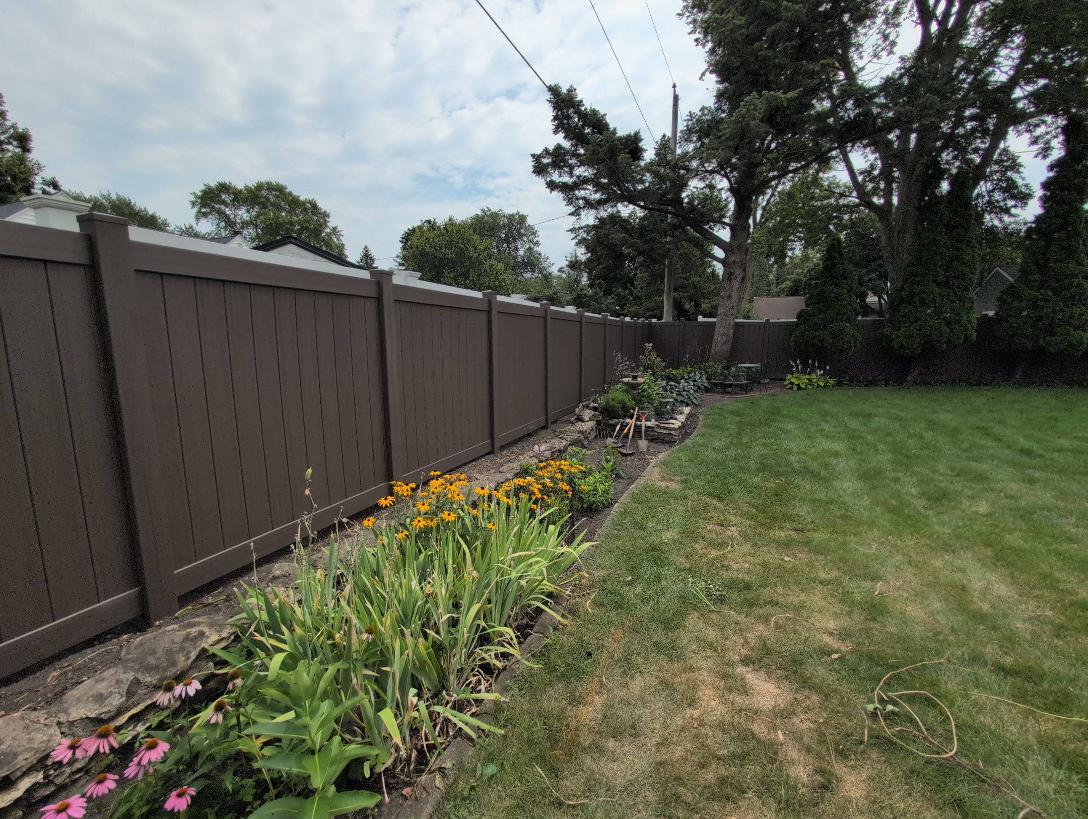 Walnut Vinyl Privacy Fence Installation in Waterloo by Perfect Picket Fence and Stain