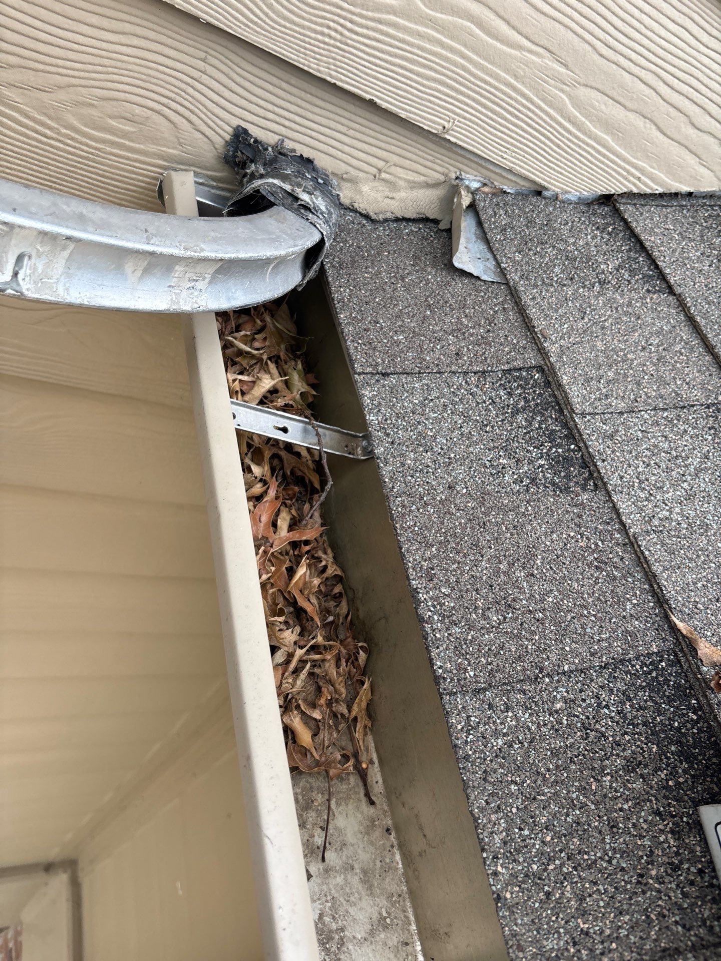 Commercial gutter cleaning Fayetteville, before photo with filled gutters