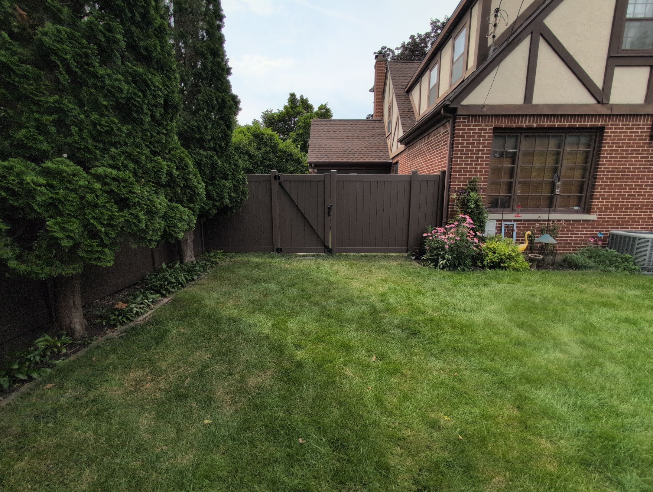 Walnut Vinyl Privacy Fence Installation in Waterloo by Perfect Picket Fence and Stain
