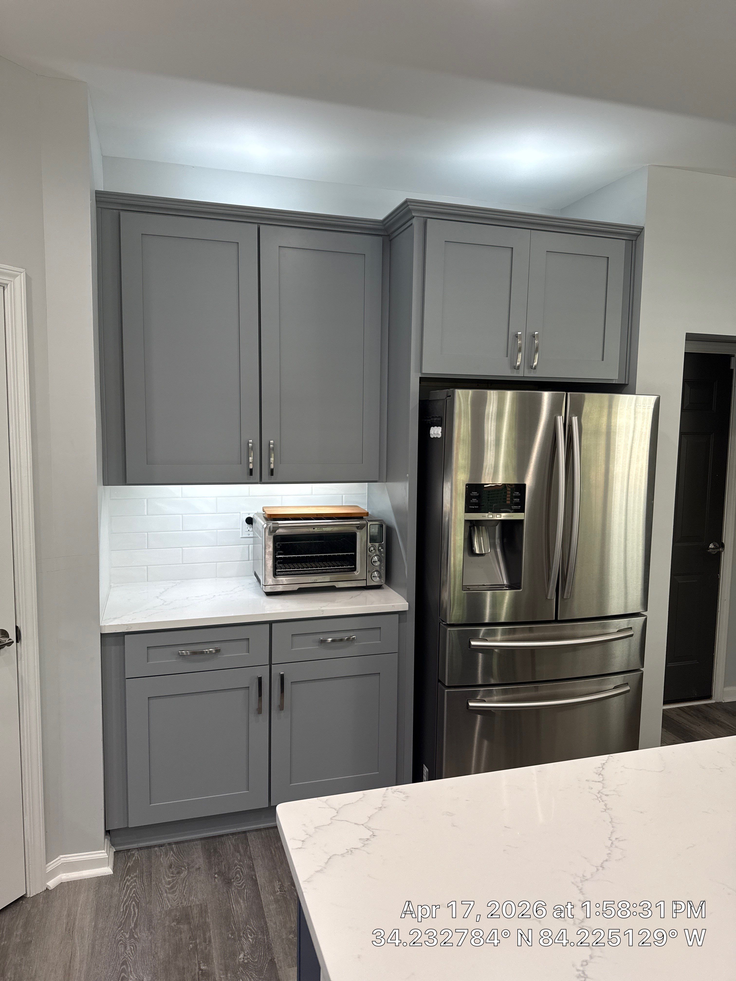 Modern Kitchen Remodel With Grey Shaker Cabinets and Navy Blue Island by Heart & Home Kitchen & Bath Remodeling LLC