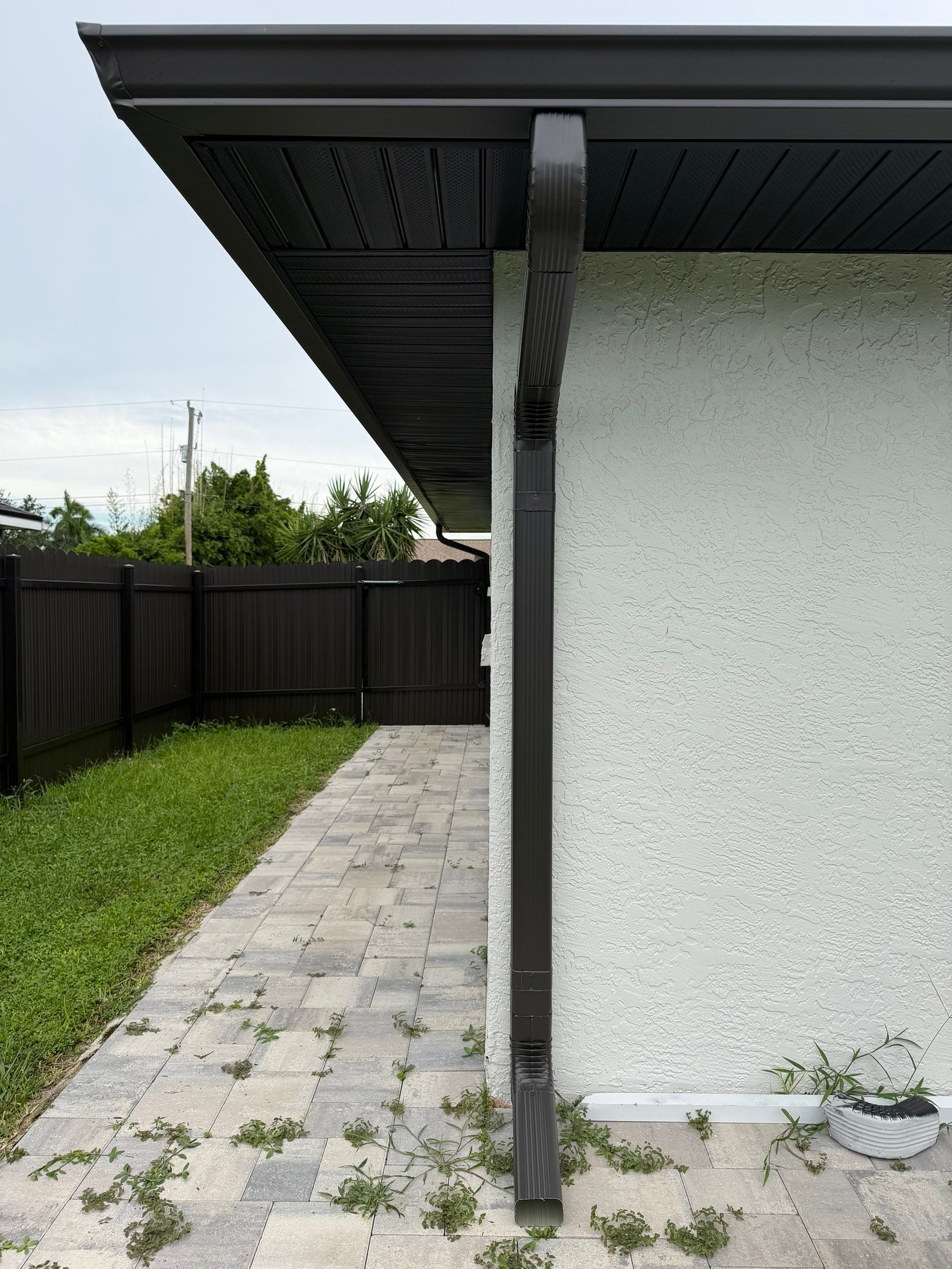 Black Seamless Gutters for a Modern Look in Cape Coral FL by Gutter Professors