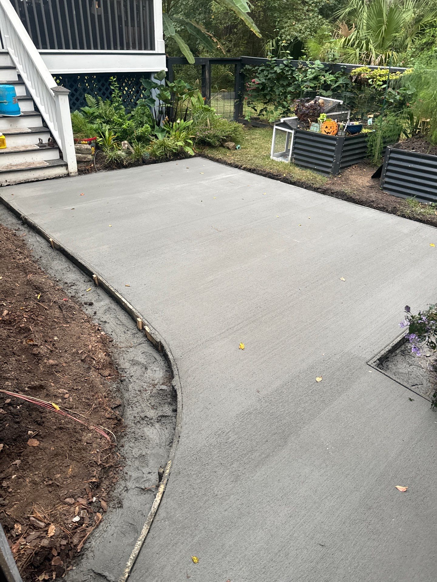 Concrete Driveway and Patio Installation With Decorative Brick Borders by Lowcountry Scapes, LLC