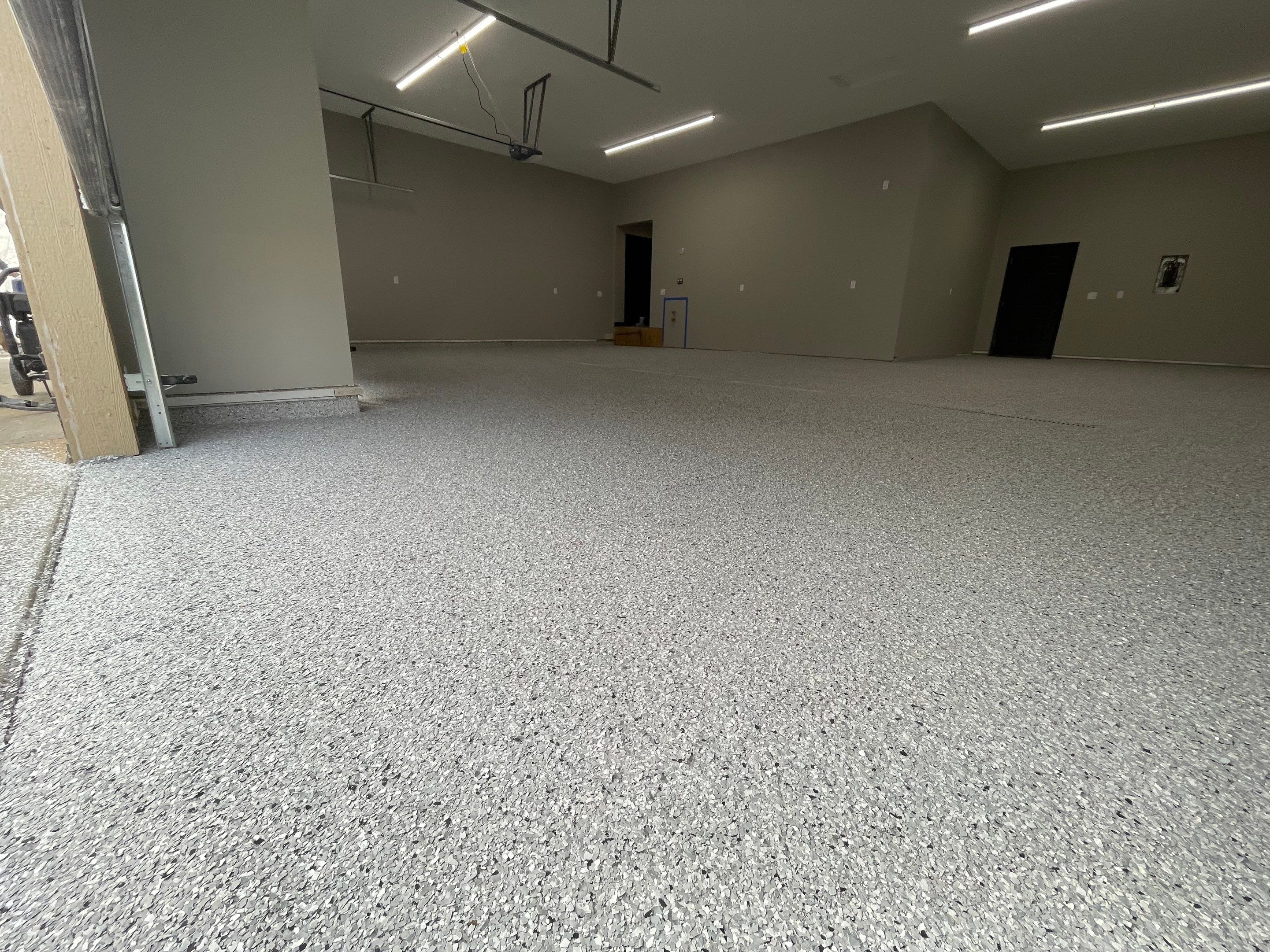 Decorative Flake Concrete Coating Installation in North Sioux City by Select Painting, Coatings & Garage Cabinets