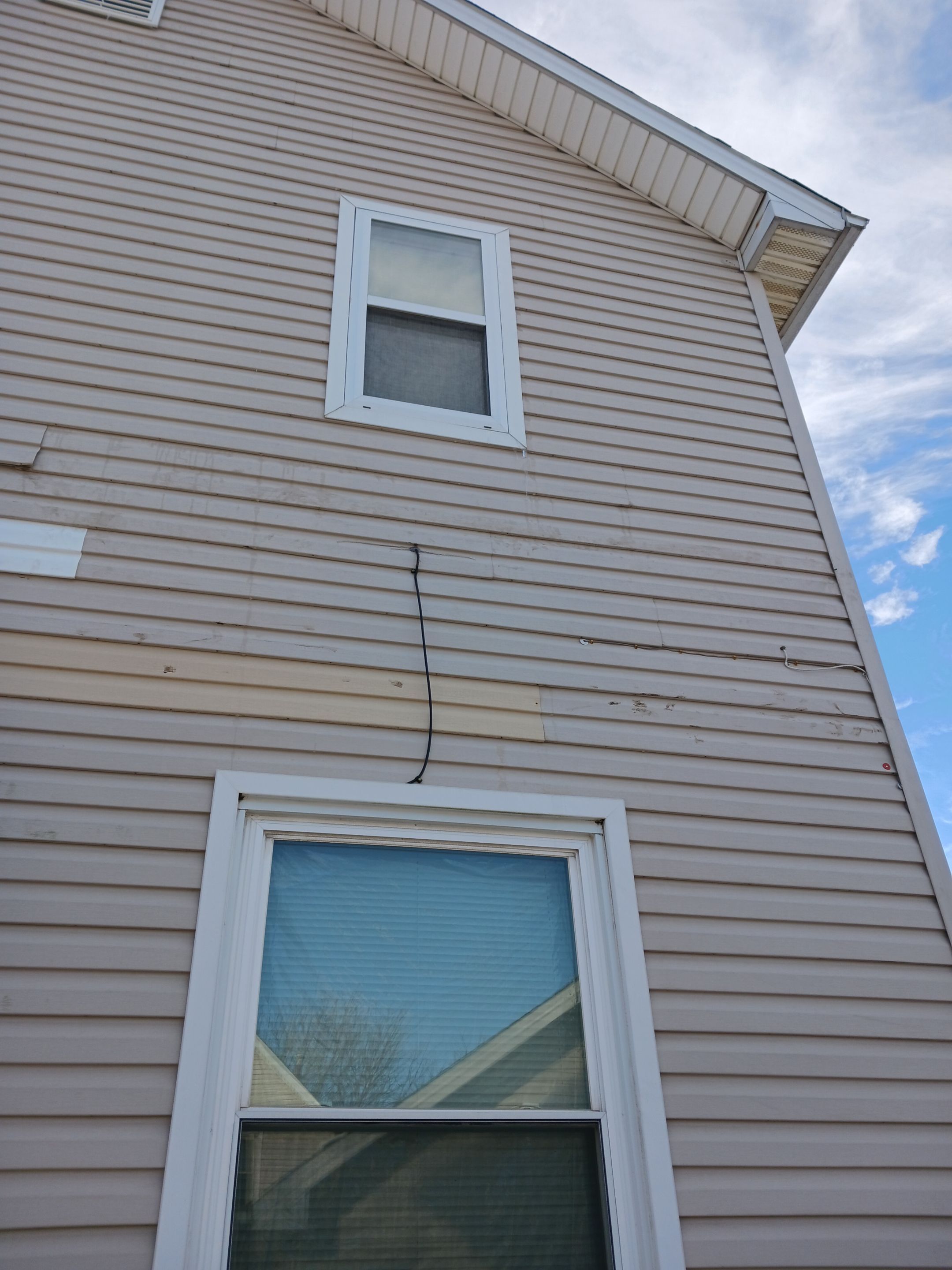 Wind damage to Siding: Insurance paid for full replacement of all siding by Absolute Roofing and Construction