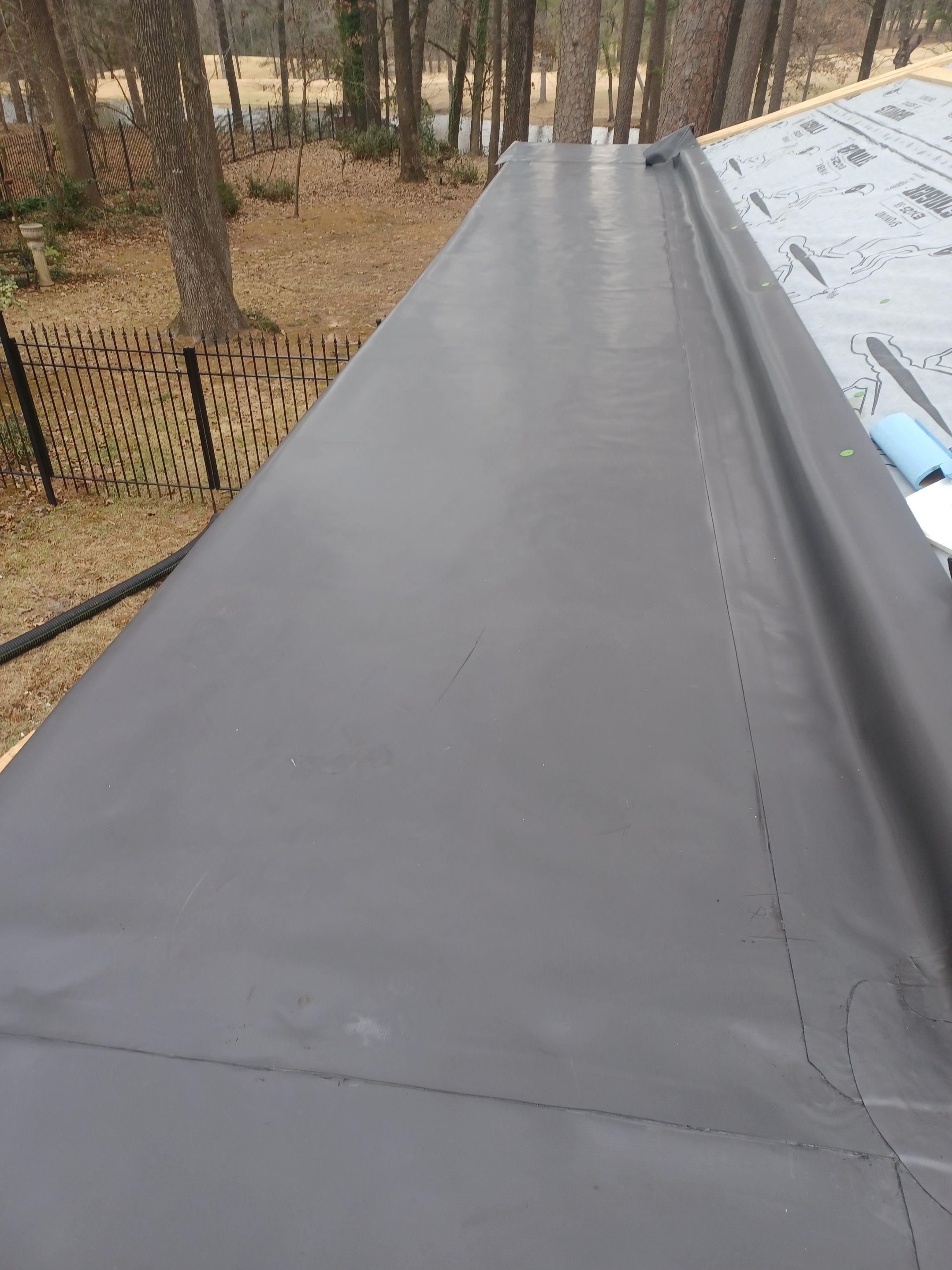 Residential Roofing Installation using PVC membrane and 24 gauge Standing Seam Metal by Hostetler Roofing