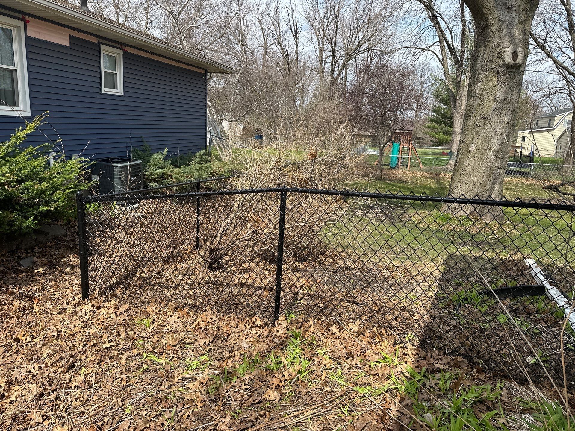 Black Vinyl-Coated Chain Link Fence Installation in Cedar Falls by Perfect Picket Fence and Stain