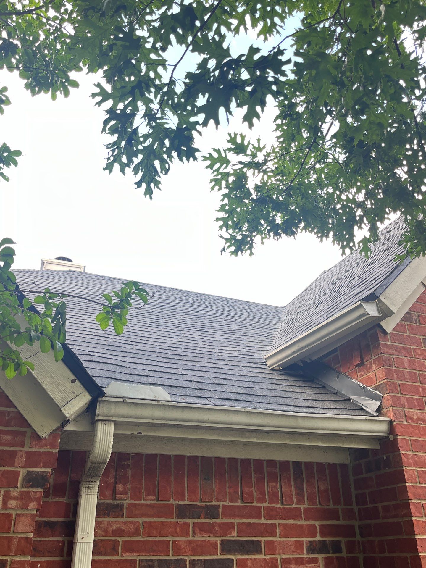 Red brick with Malarkey Midnight Black  by Tejas Roofworks + Restoration