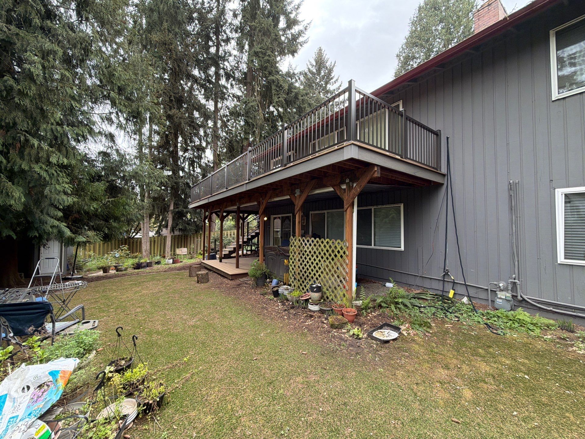 Elevated TimberTech Composite Deck Replacement With Black Metal Railings by Emerald City Energy