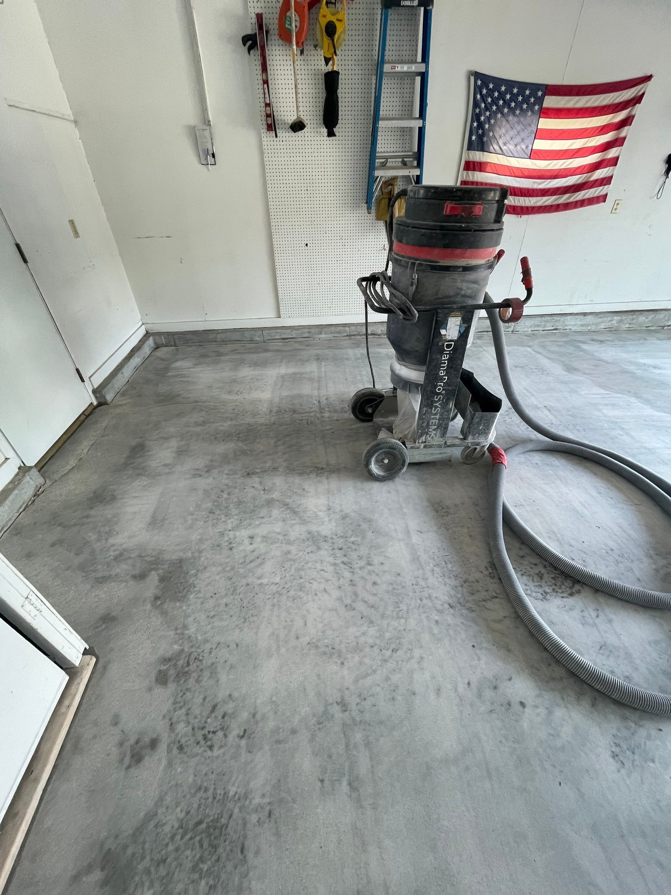 Residential Garage Floor Coating with Feather Grey Finish in Sioux Falls by Select Painting, Coatings & Garage Cabinets