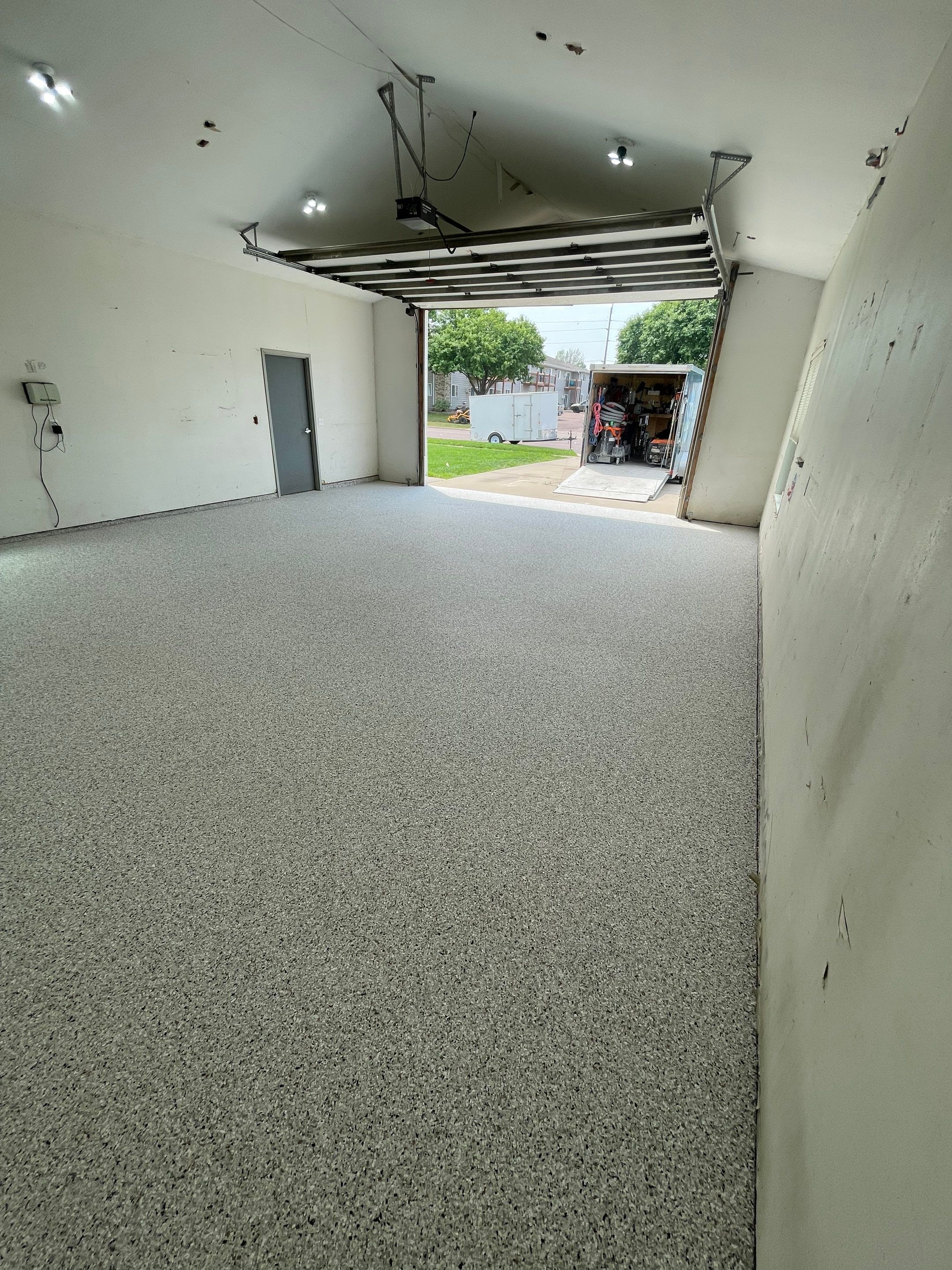 Coyote Flake Concrete Coating for Sioux Falls Garage by Select Painting, Coatings & Garage Cabinets