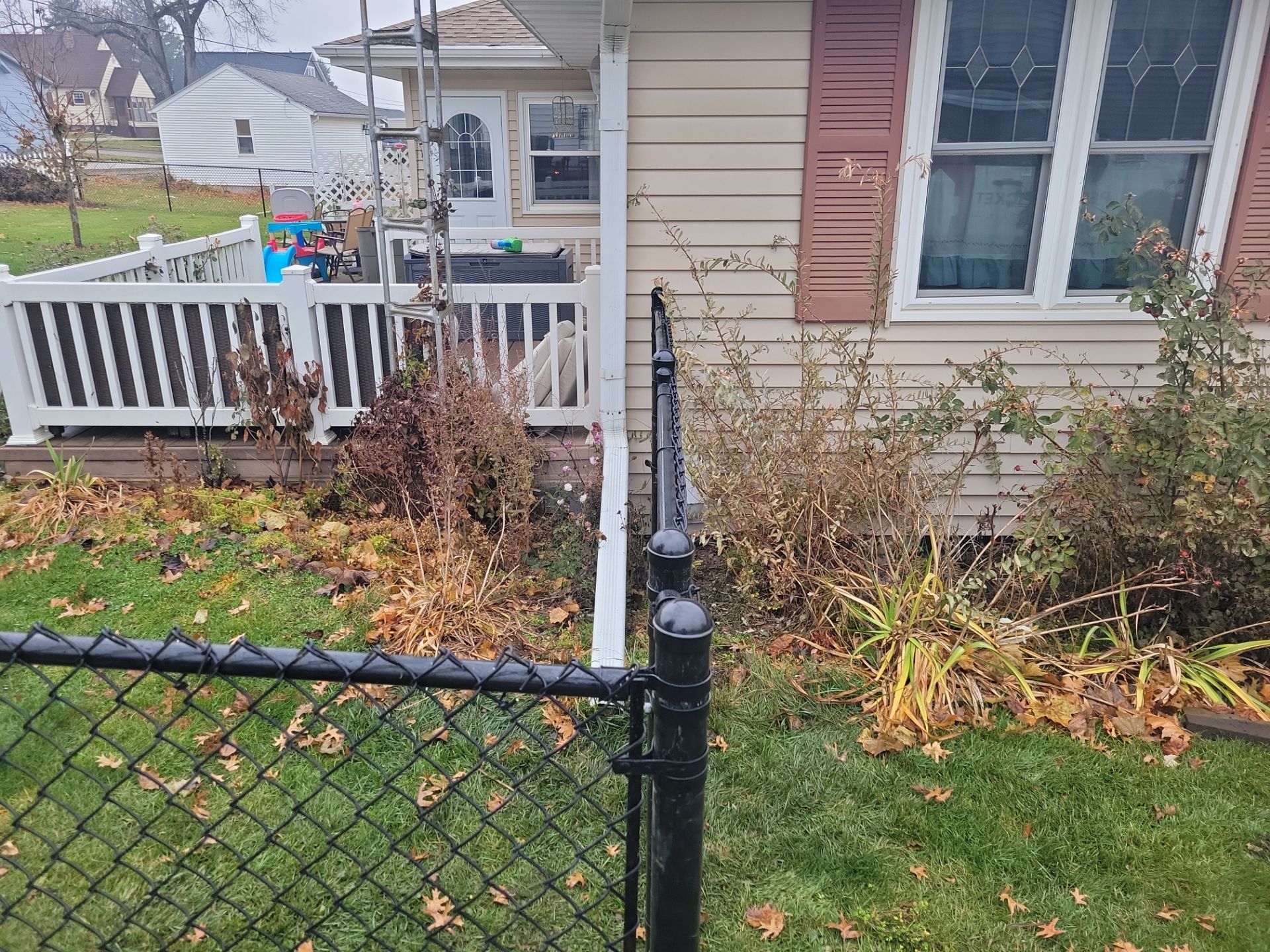 Black Vinyl-Coated Chain Link Fence Installation in Aplington by Perfect Picket Fence and Stain