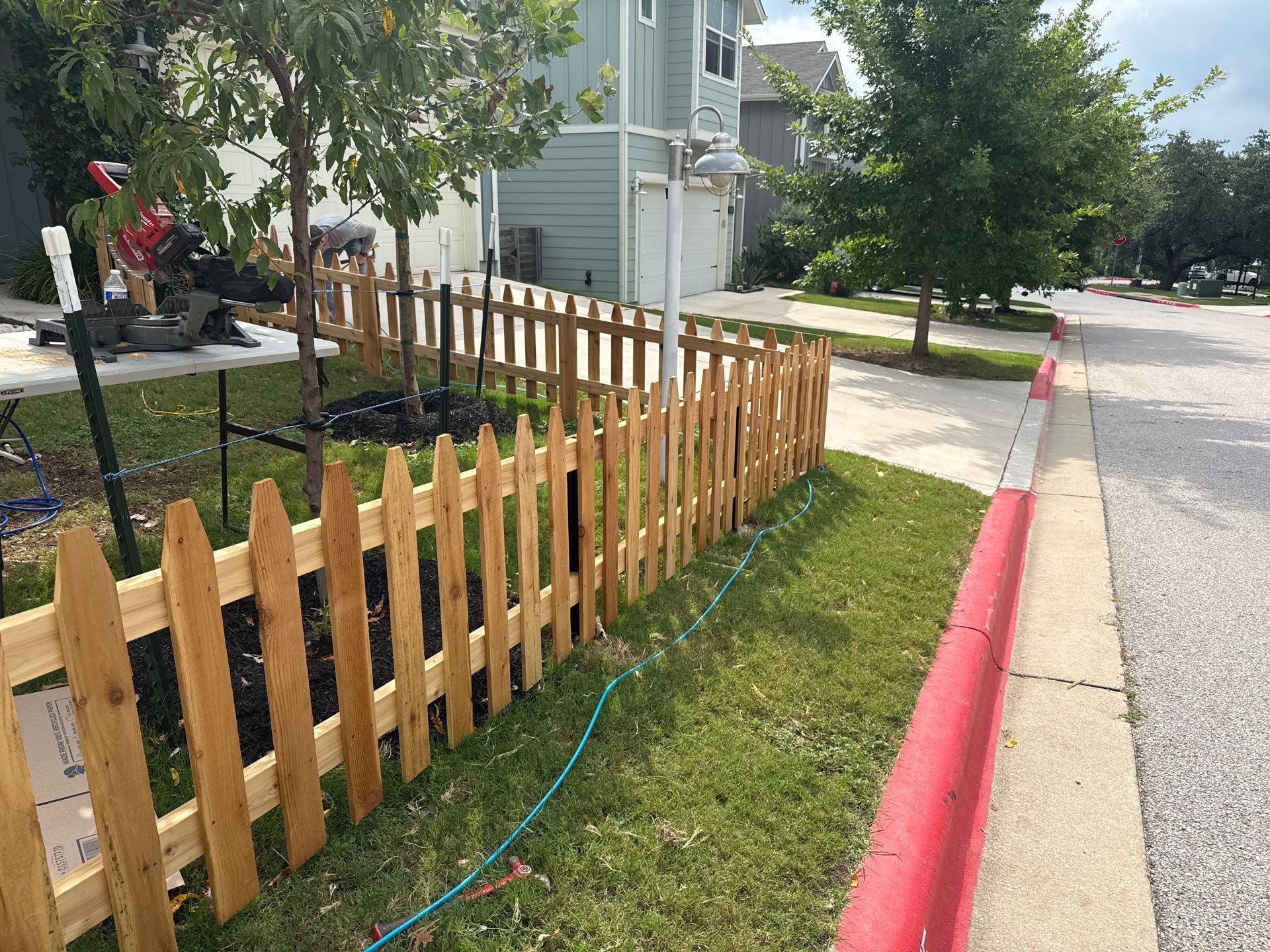 Austin Residential Wooden Picket Fence Installation and Solid Color Staining by Rhino Home Care