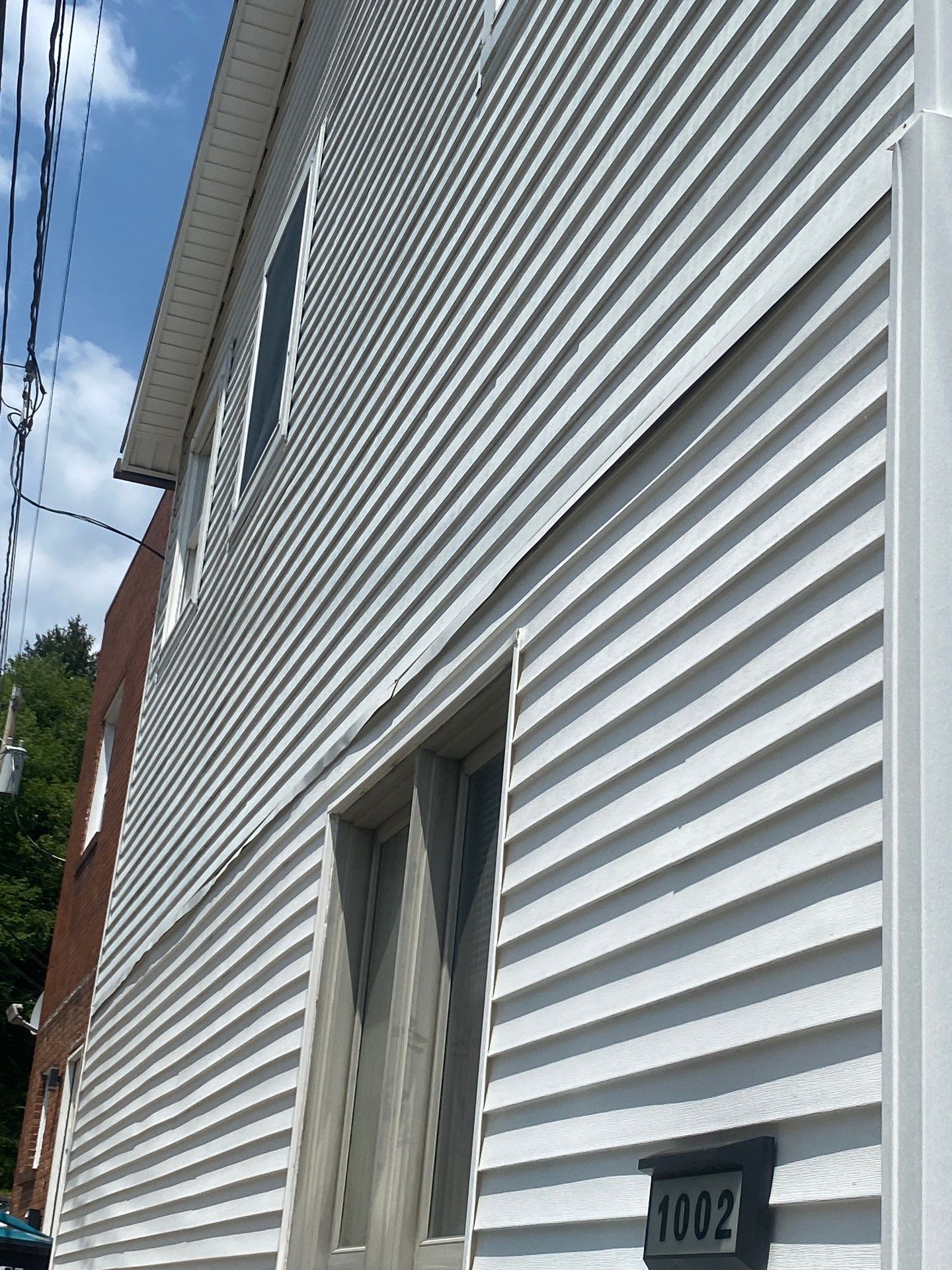 White siding  by Cousins Roofing Siding & Decks