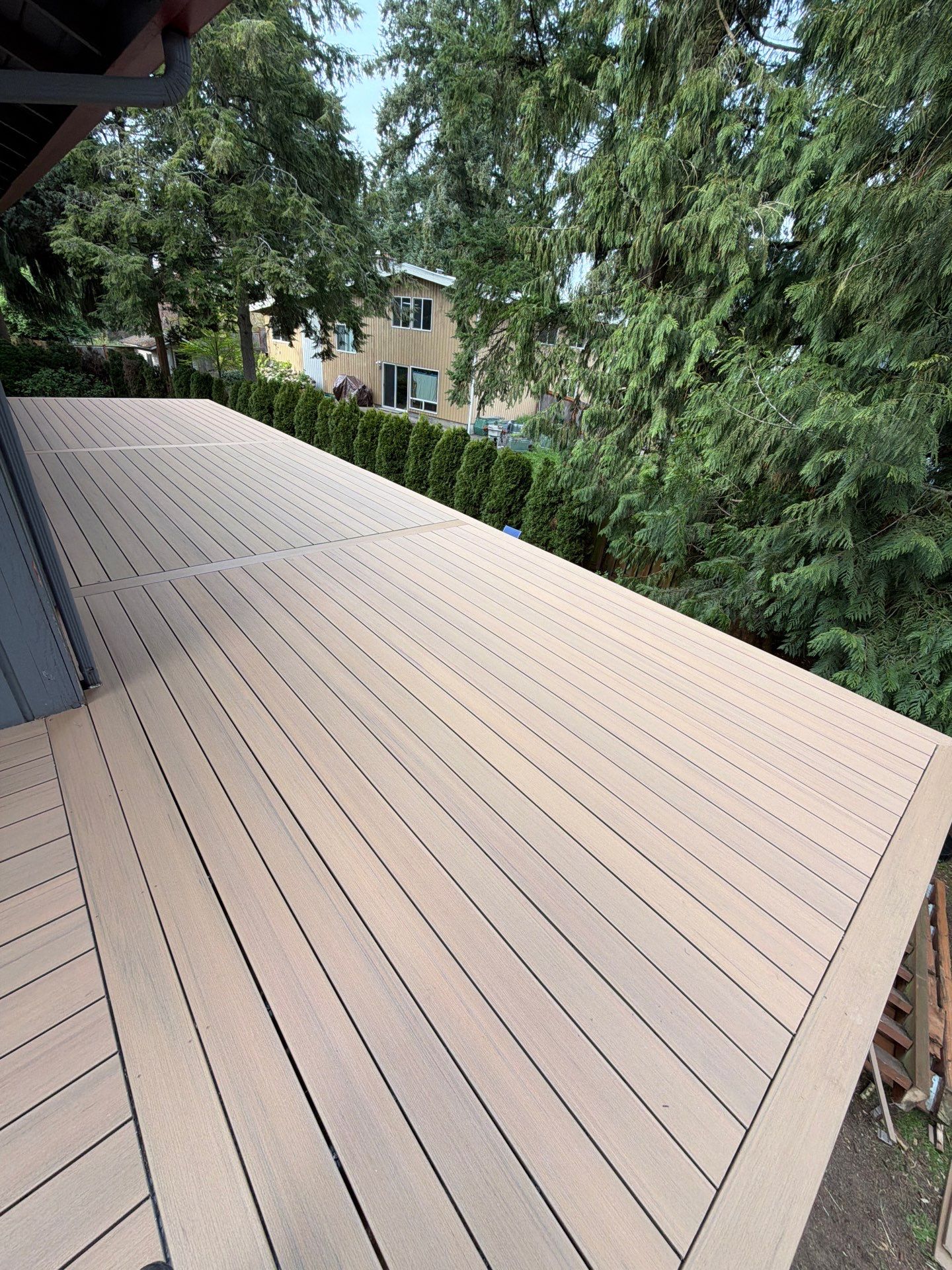 Elevated TimberTech Composite Deck Replacement With Black Metal Railings by Emerald City Energy