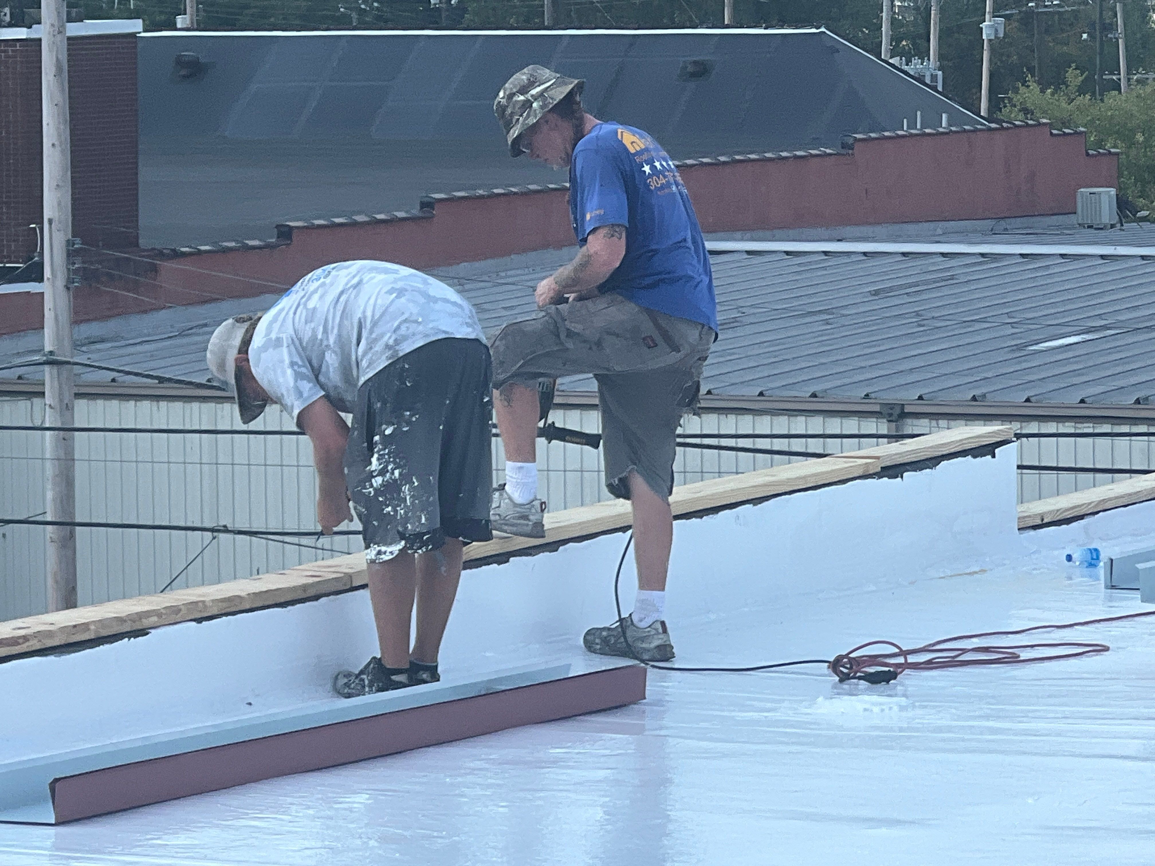 Commercial Roofing Installation using smartcoat Roof coating by Fahey Roofing + Contracting