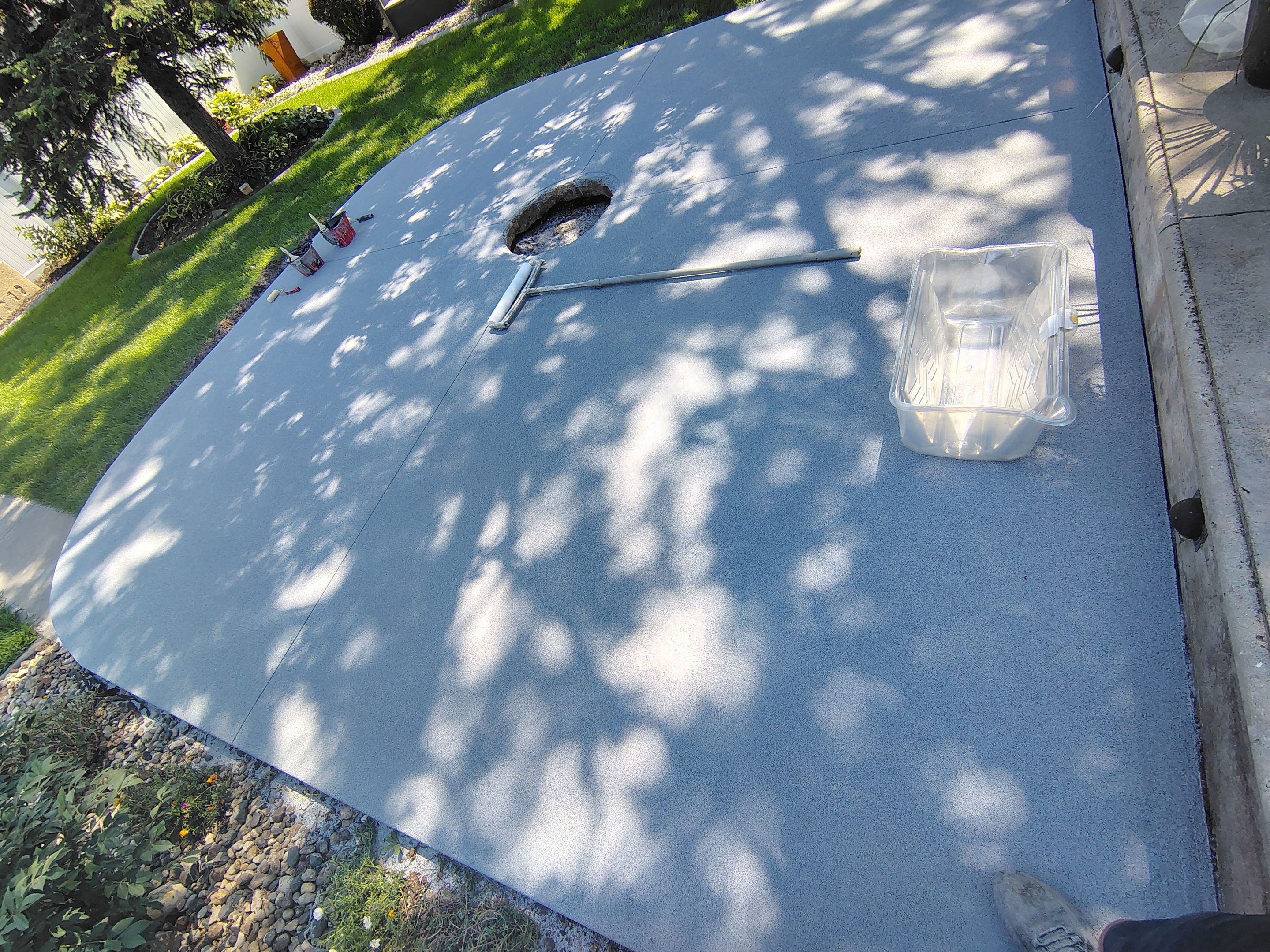 Custom Garage Floor Coating and Backyard Patio Refinishing in Tyndall by Select Painting, Coatings & Garage Cabinets
