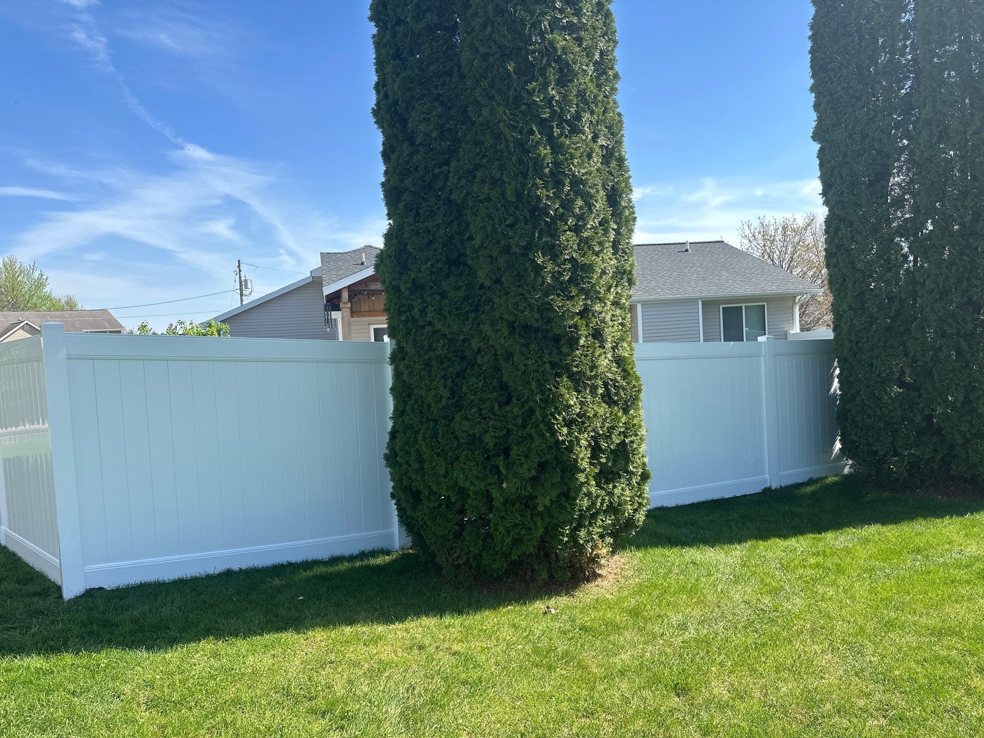 White Vinyl Privacy Fence Installation in Raymond, Iowa by Perfect Picket Fence and Stain