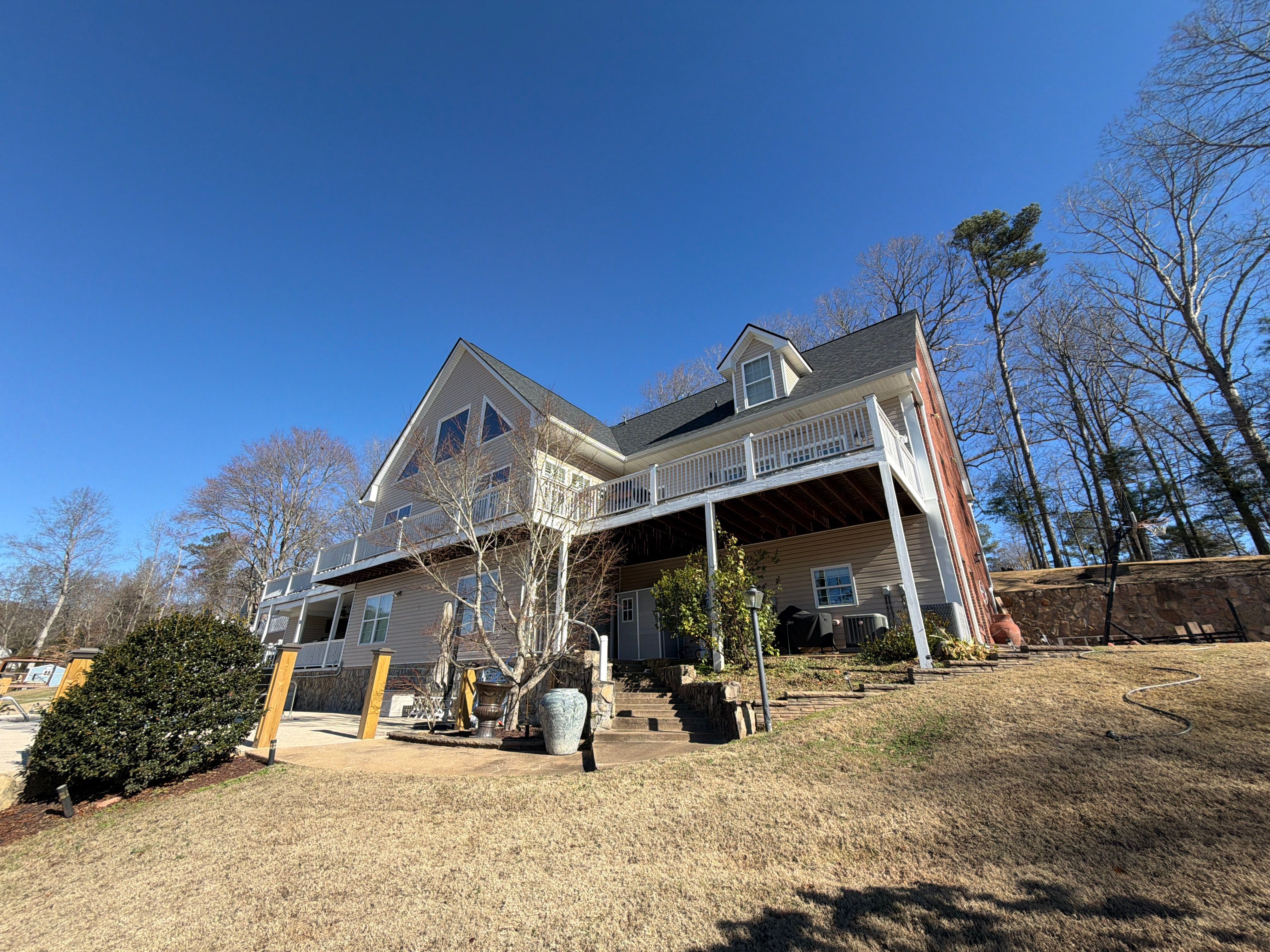 Cumming, GA Lake House Deck Resurface and Extension using Pressure Treated Pine and Skyline Cable Railing by Nelson Exteriors 