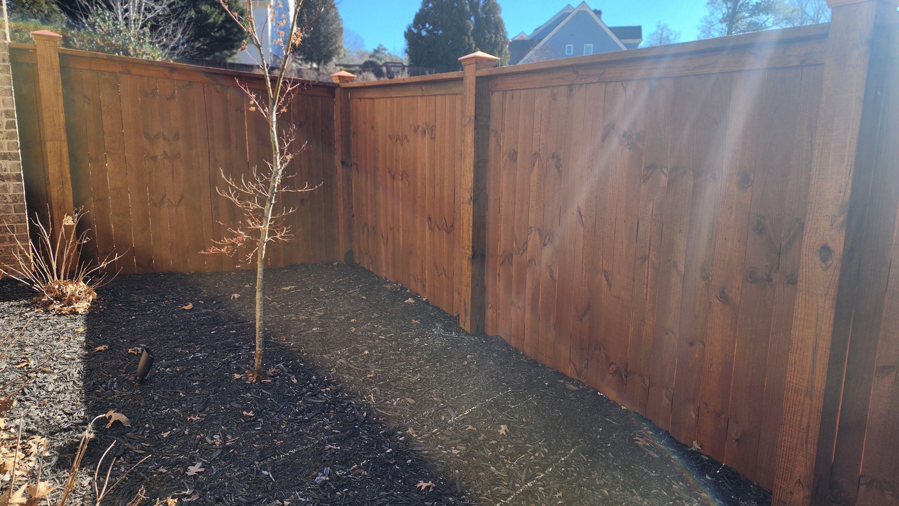 Fence Installation of Capped Wood Privacy Fence using 6X6 posts and copper post caps.  by Titans of Timber Fence & Stain